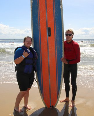 Surfers Healing, a California-based nonprofit that offers a day of surf camp for those with autism and other developmental disabilities, was at Ditch Plains in Montauk on Friday. The camp was underwritten by East End Disability Associates and receives volunteer support from the East Hampton Volunteer Ocean Rescue squad and the Montauk Lions Club. Katie Keisner with volunteer Blake Michaels. KYRIL BROMLEY