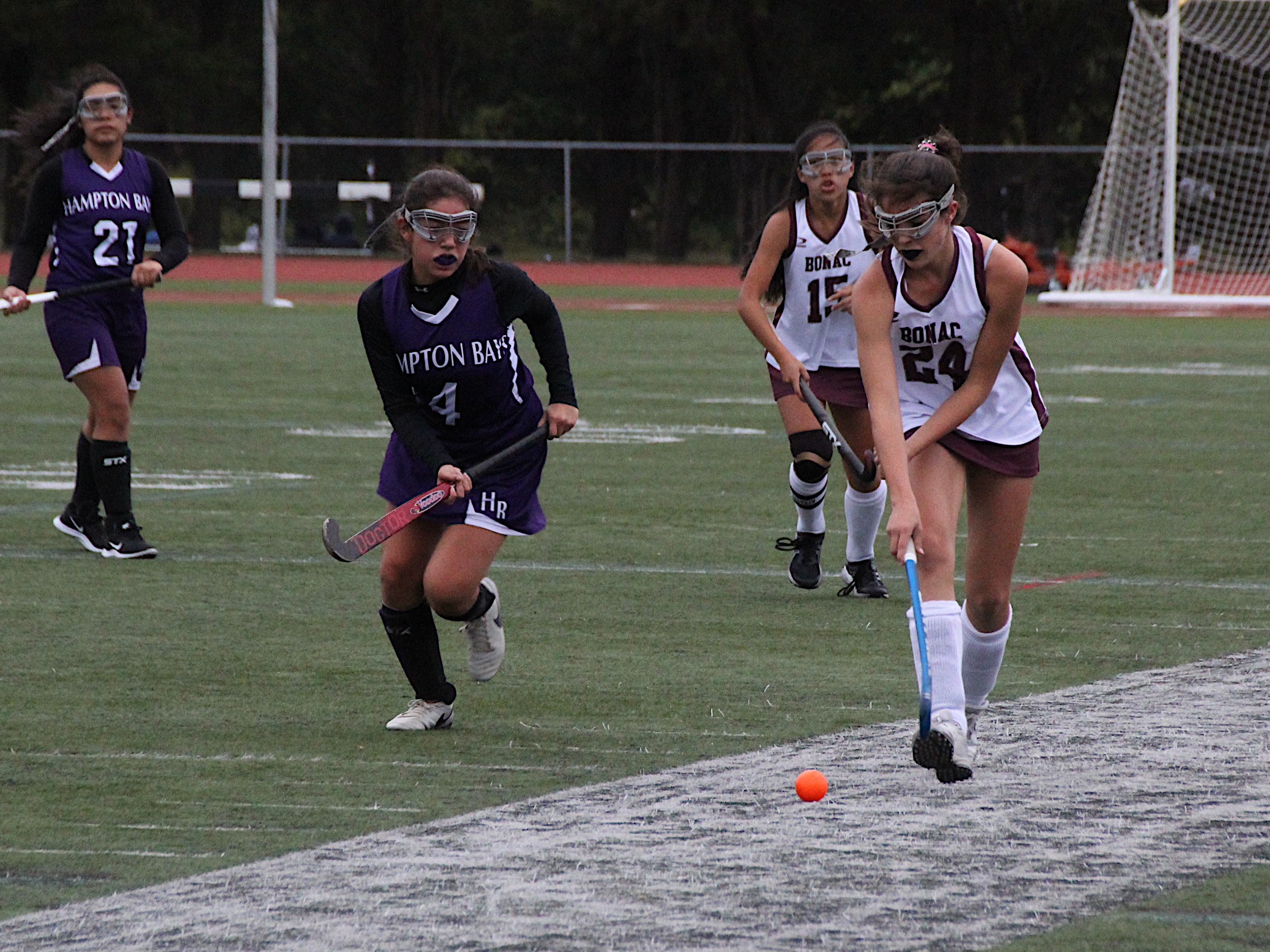 East Hampton eighth-grader Melina Sarlo races the ball downfield with Hampton Bays sophomore Angie Chinchilima chasing after her.