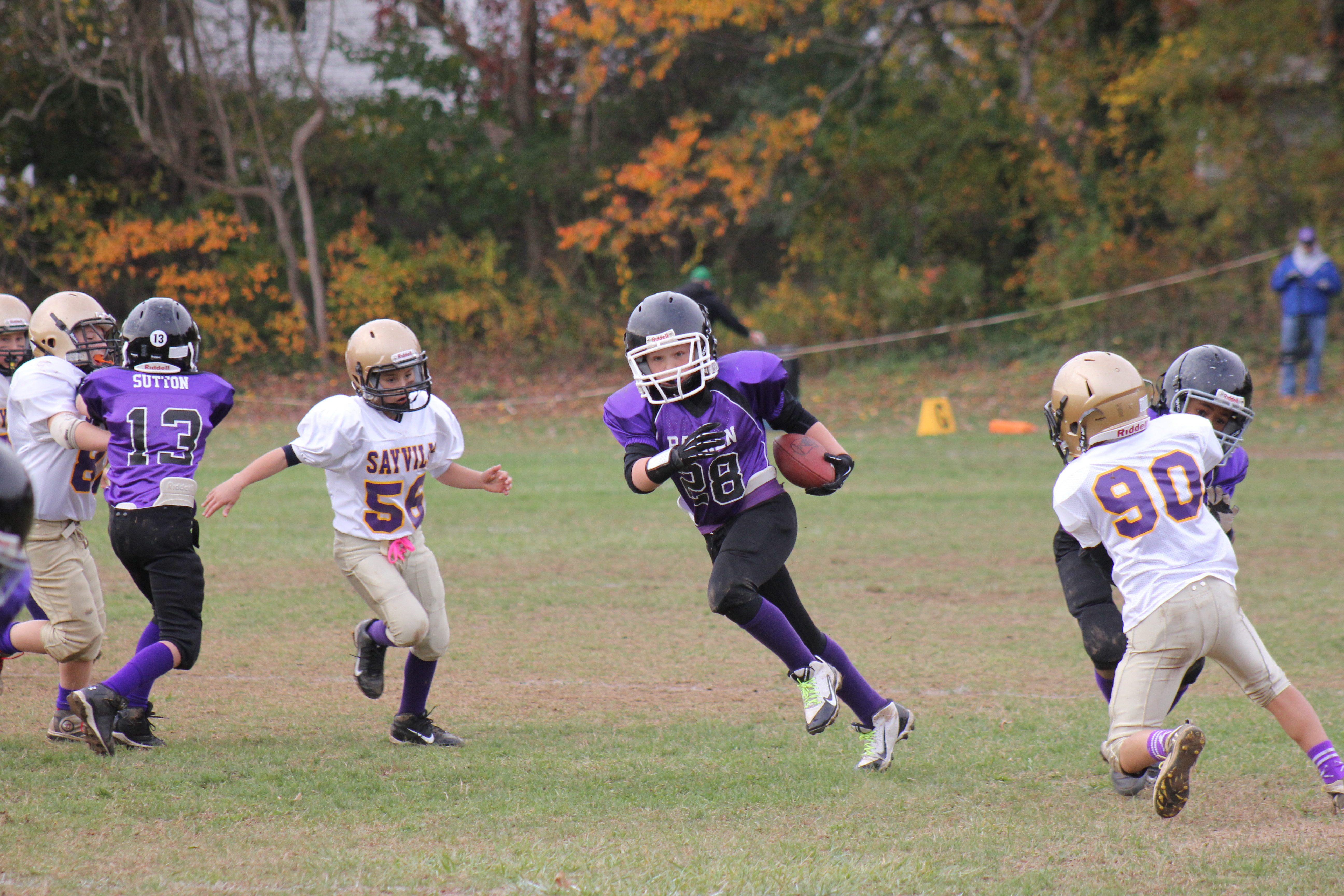 Dylan Schultheis finds a hole thanks to blocks from teammates Stephen Sutton, left, and Kazmin Johnson.