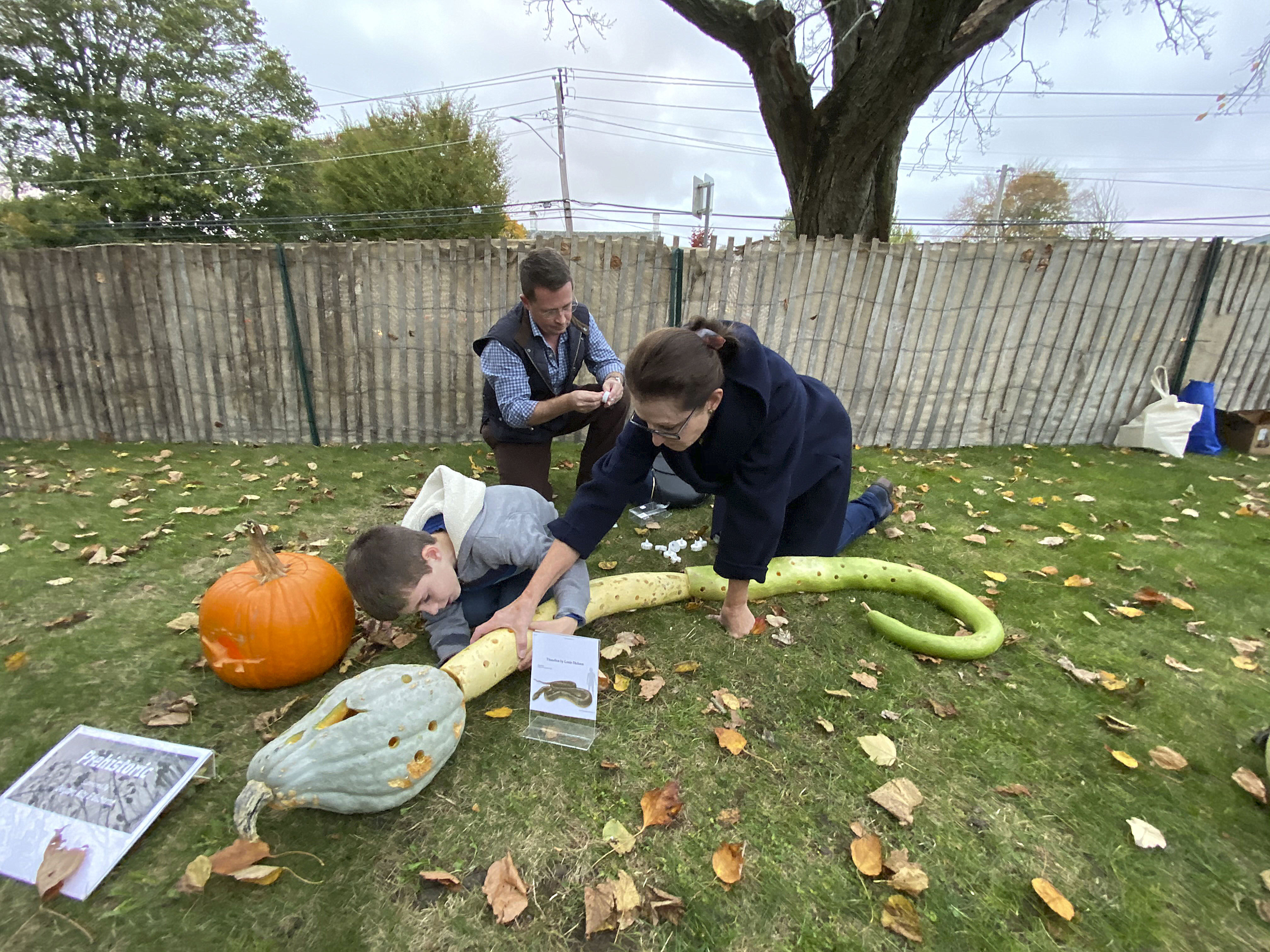 Louie, Ted and Erin Dickson work on their snake.