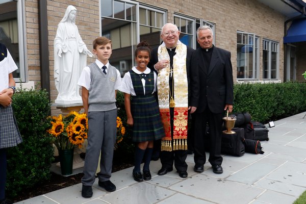 Our Lady of the Hamptons School in Southampton hosted a dedication ceremony for its new playground last week. Students Cooper Sanders and Aliah Donohoe celebrate the dedication of Our Lady’s statue with Bishop Murphy and Father Peter DeSanctis.