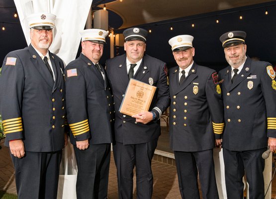 The Southampton Town Fire Chiefs Council honored East End firefighters and EMTs of the year at a dinner at Dockers restaurant in East Quogue on Saturday. Gary M. Wilson Jr. was the recipient of the Sag Harbor Fire Department’s Firefighter of the Year Award. From  left, Southampton Fire Department Ex-chief Buddy Wines, Southampton Fire Department Ex-chief Mike Kampf, Mr. Wilson Jr., Sag Harbor Fire Department Chief Steven Miller, and Quogue Fire Department Ex-chief Ed McGrath. Courtesy Westhampton Beach Fire Department