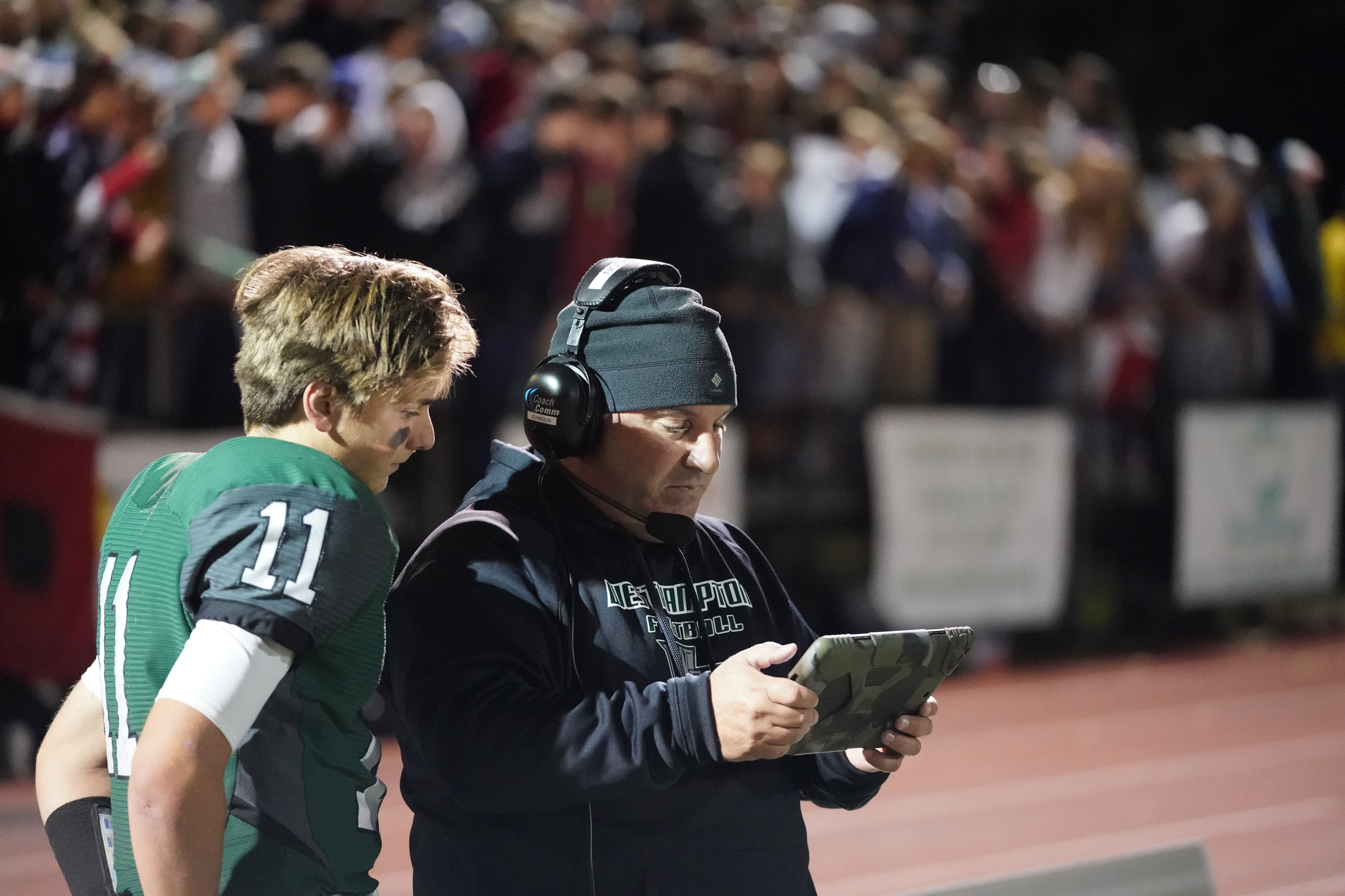 Westhampton Beach offensive coordinator Mark Johnson goes over plays with his quarterback Christian Capuano.