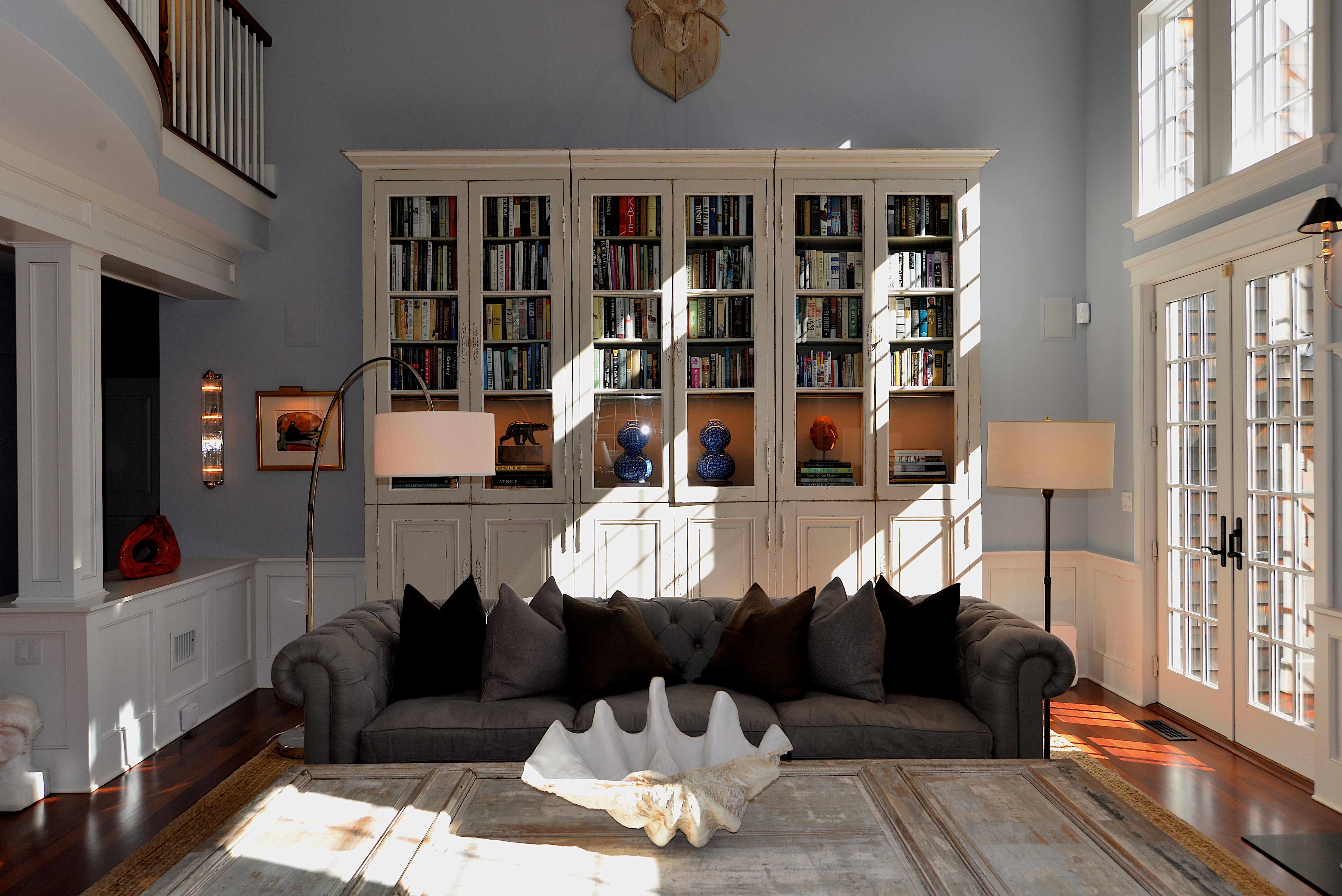 A nearly 12-foot-tall French country bookcase built in three sections and modified with lighting elements.