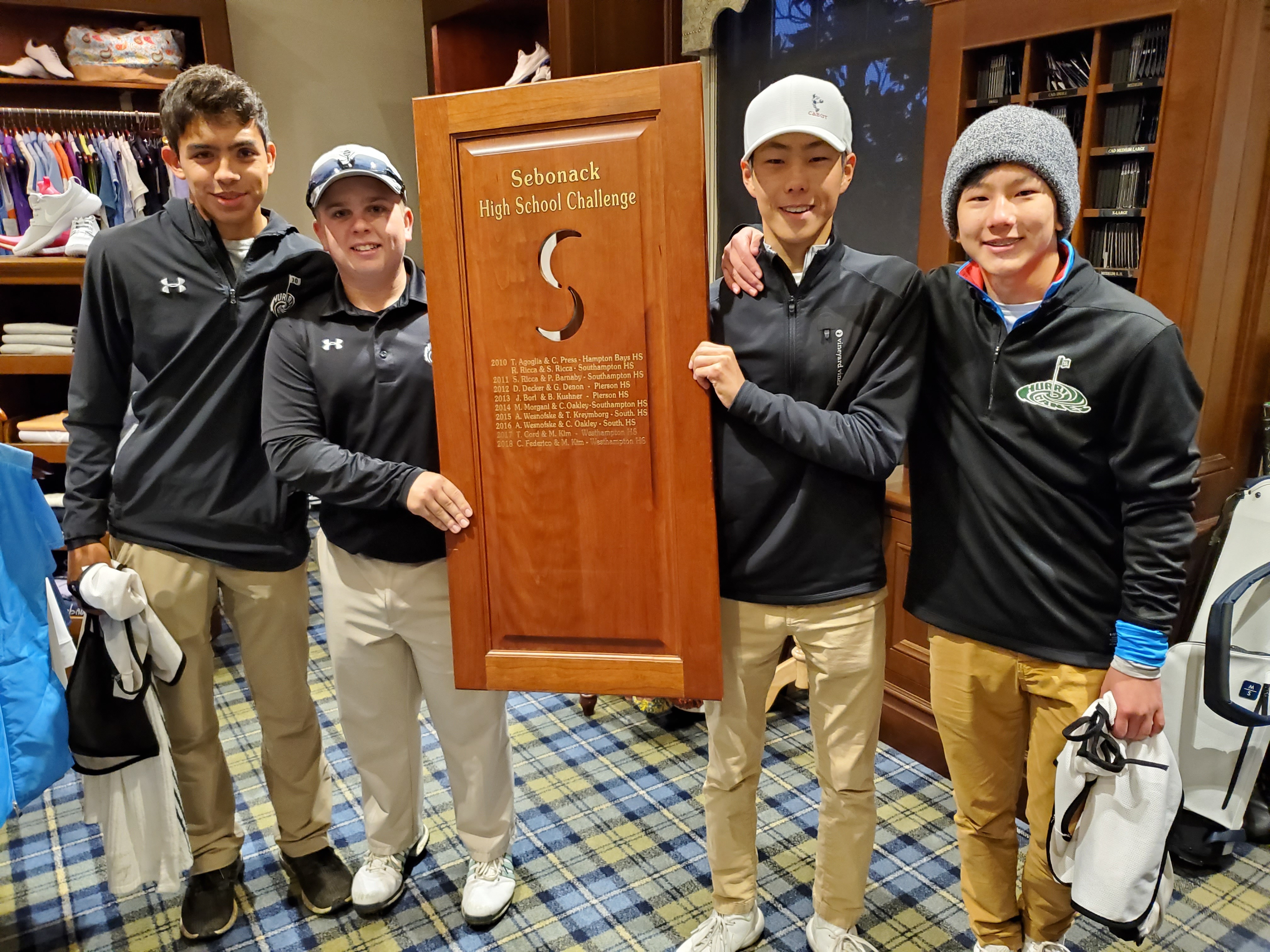 From left, Tyler Puch, Cole Federico, Mackenzie Kim and Cooper Kim are bringing back their plaque to Westhampton Beach.