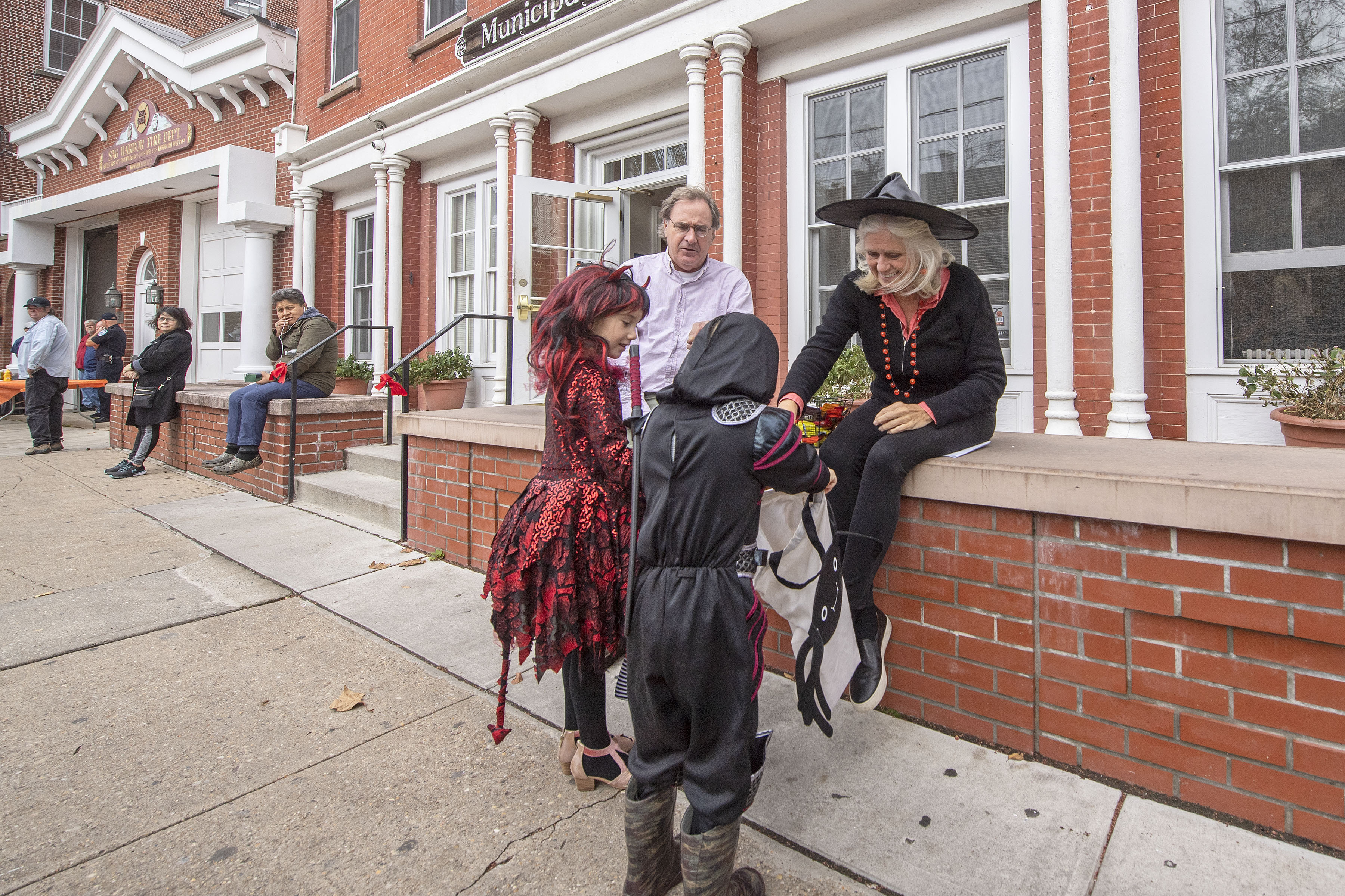 Sag Harbor Village Mayor Kathleen Mulcahy hands out candy on the steps of Village Hall during the 2019 Pumpkin Trail on Main Street on Thursday, October 31. MICHAEL HELLER