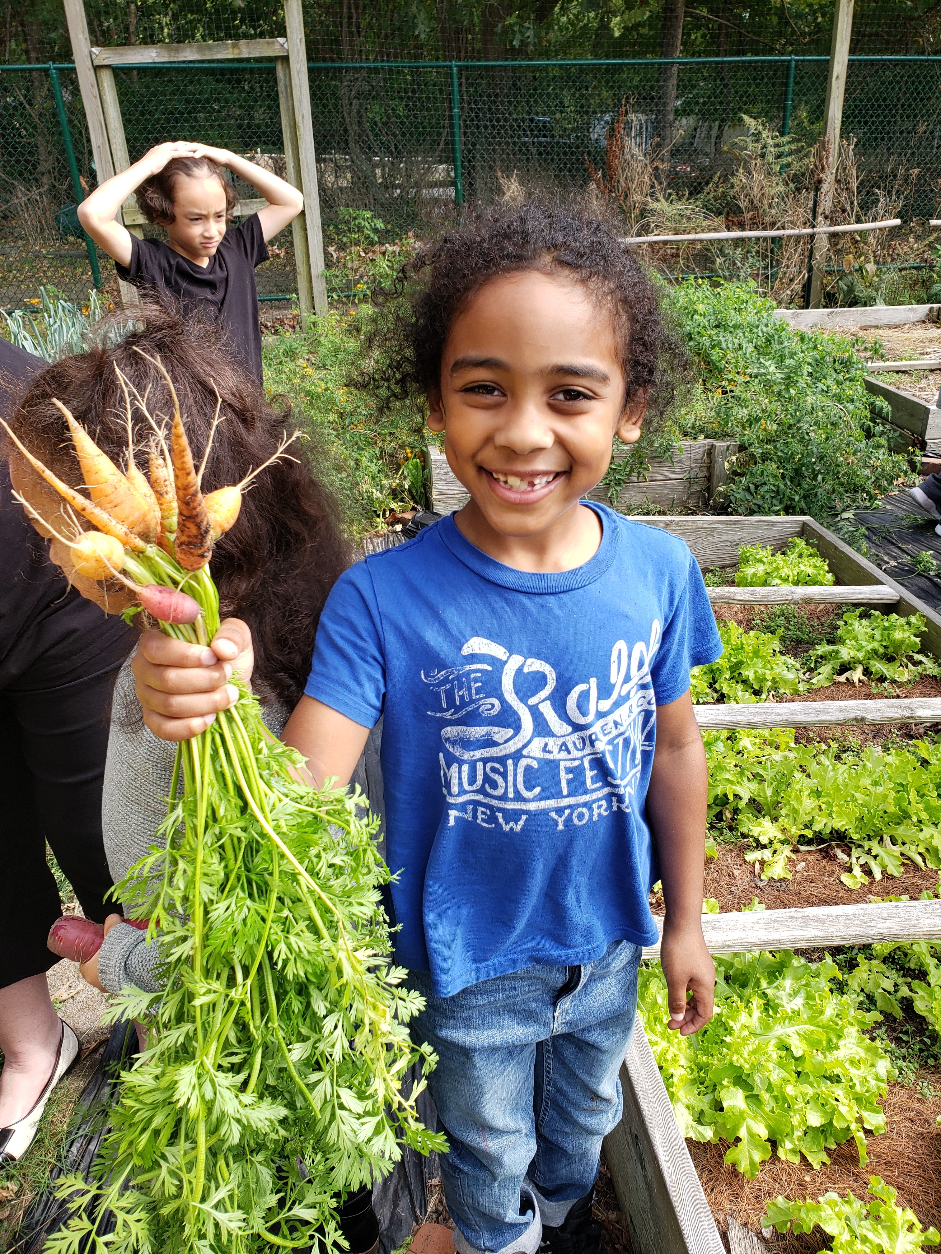 In early October, Tuckahoe School’s second-graders  helped harvest carrots from the school's garden. Isaiah Chai with the bounty. 
