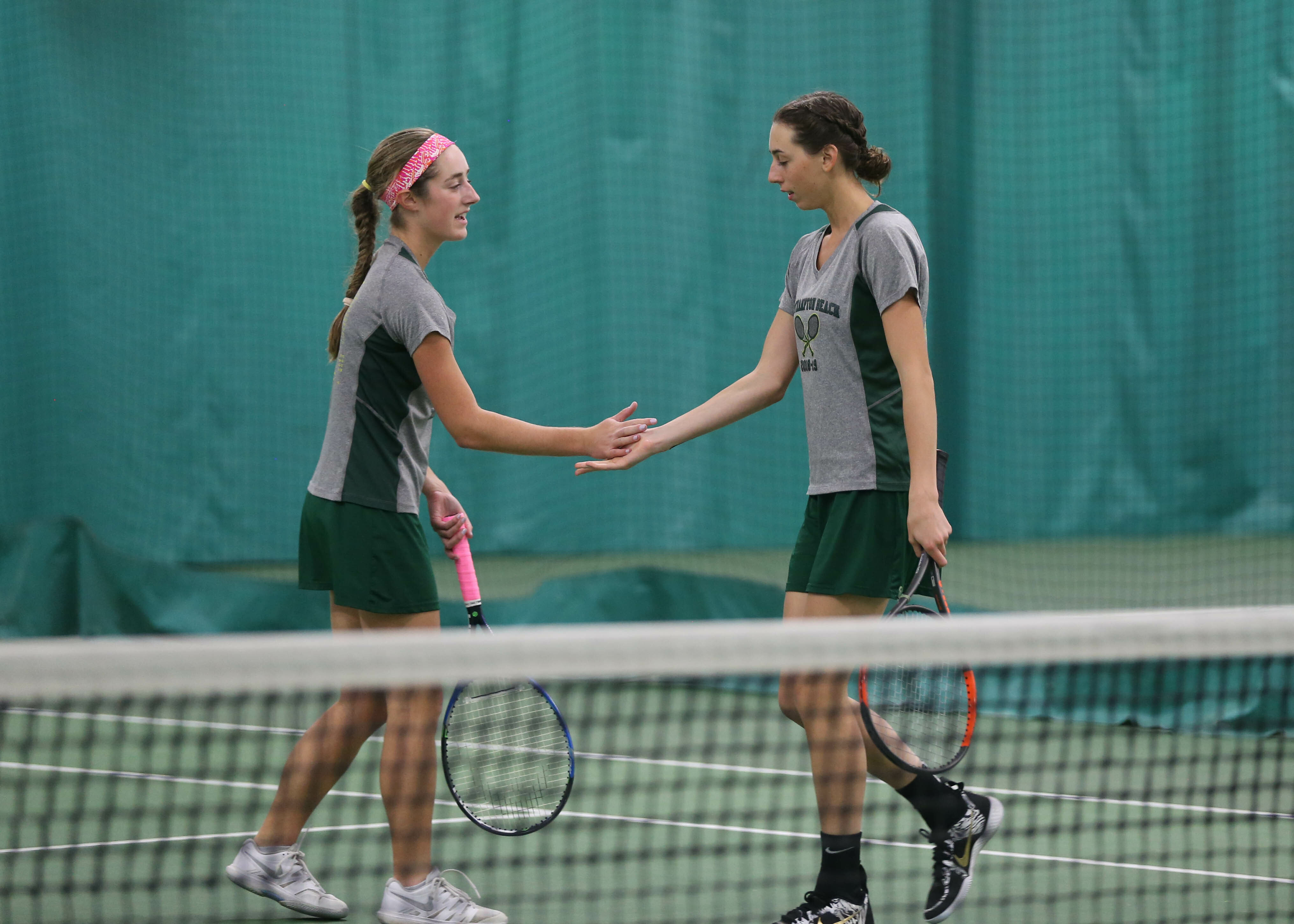 and Jen Curran congratulate each other on a point in their doubles match at states. GABE RODRIGUEZ