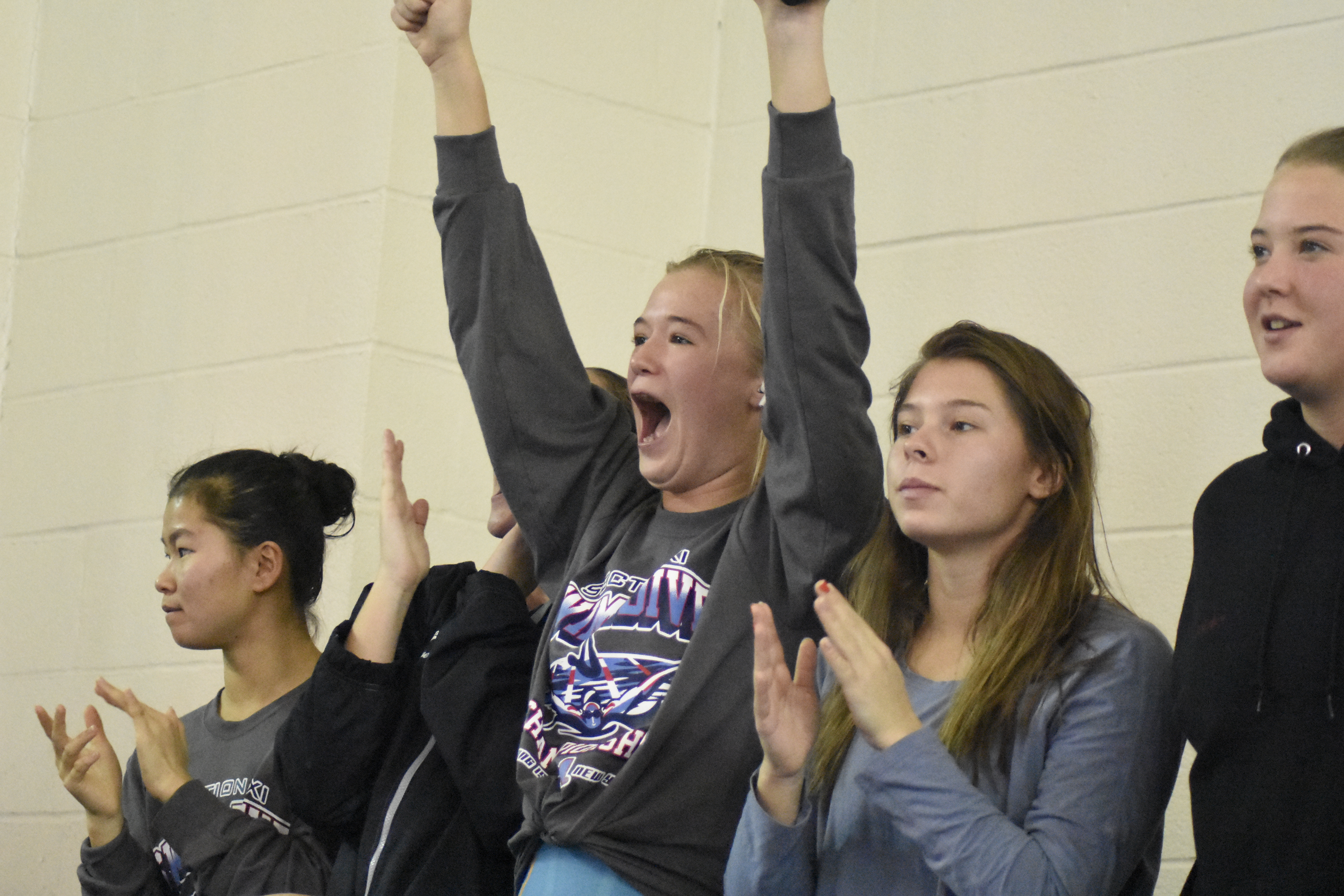 Caroline Brown reacts to her teammate Sophia Swanson's third-place finish in the 100 free.