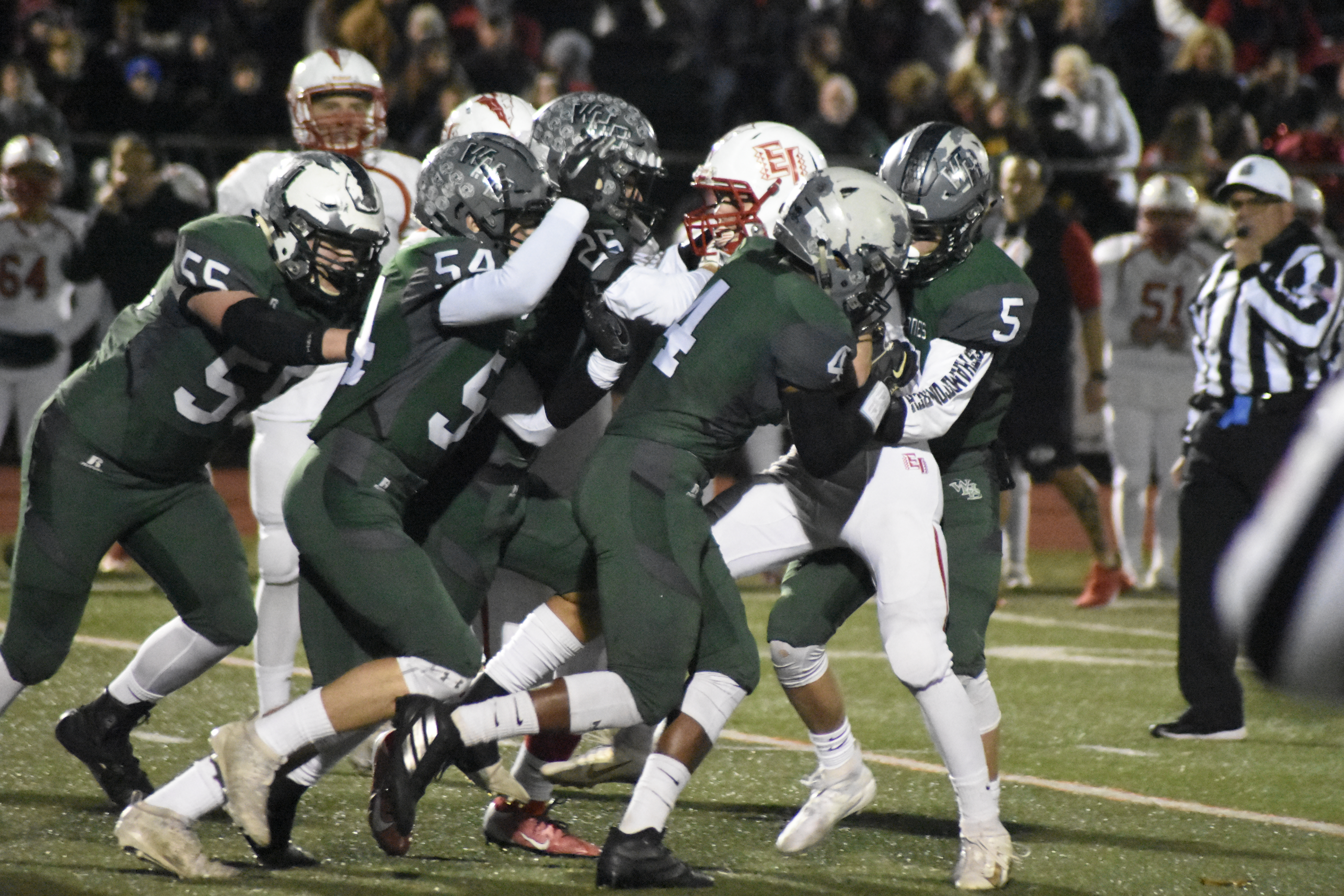 Matt Leotta (5), Shavar Coffey (4) and a host of other 'Canes get to an East Islip player.