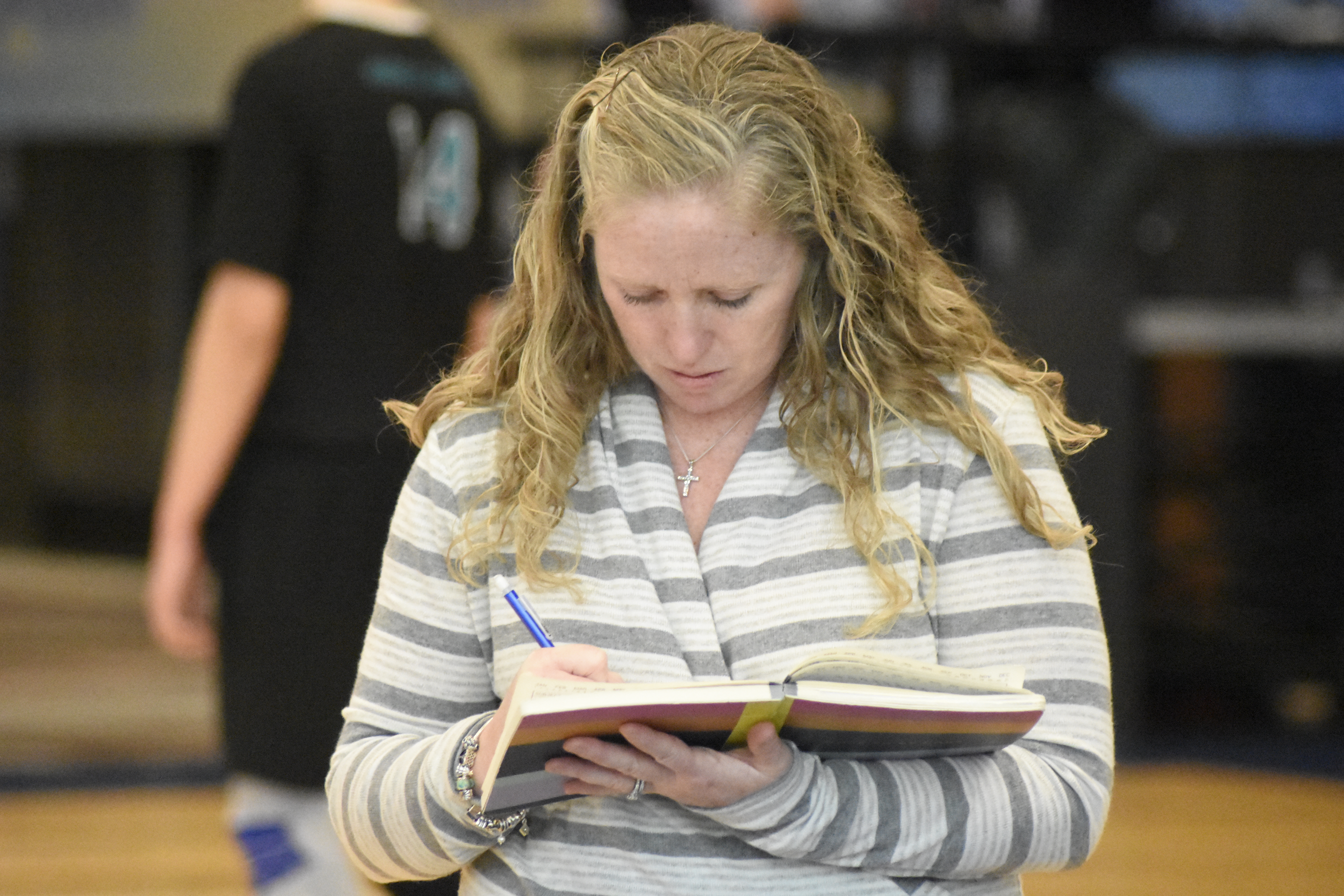 Westhampton Beach head coach Jackie Reed jots down a few notes in her book.