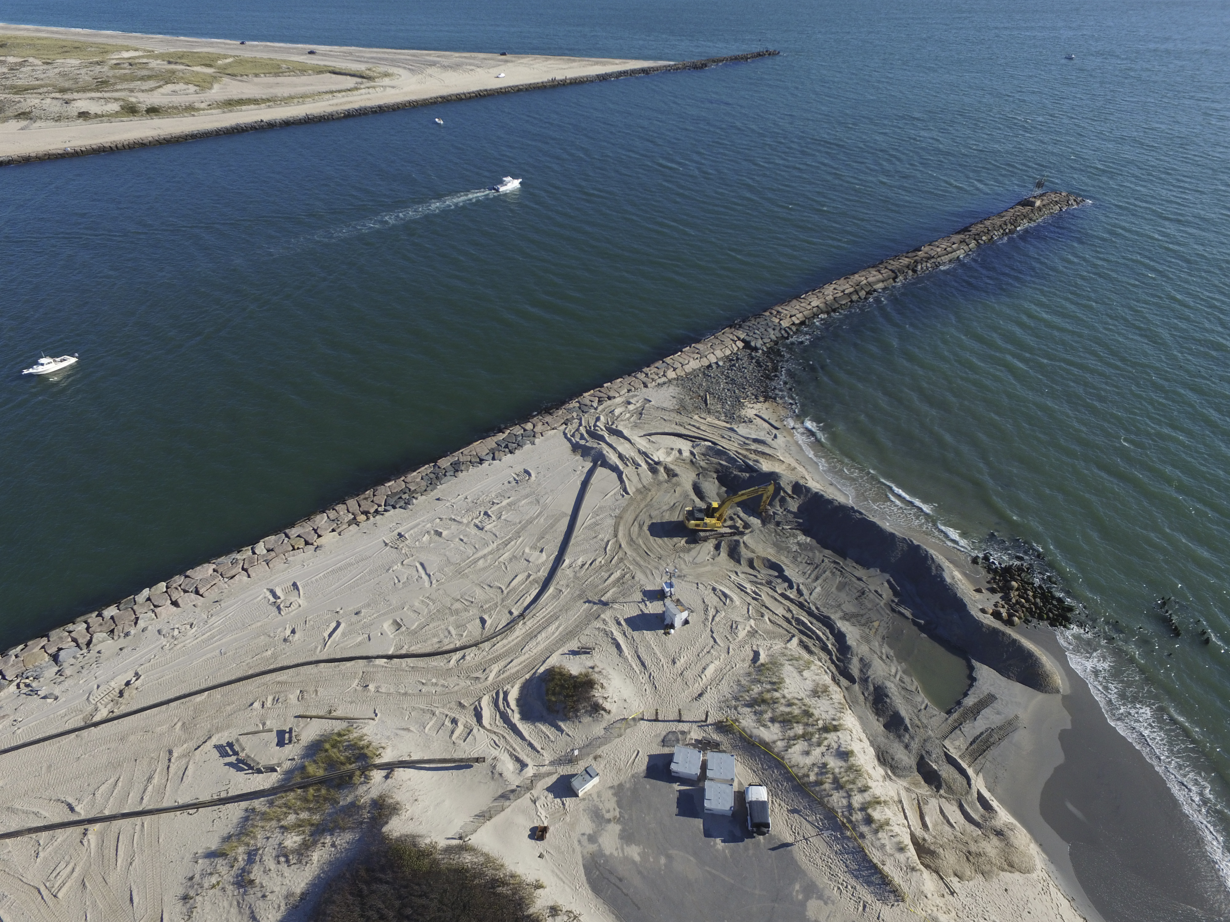 Crews at work on the emergency dredging operation to widen the beach just west of the Shinnecock Canal in Hampton Bays on Monday.  