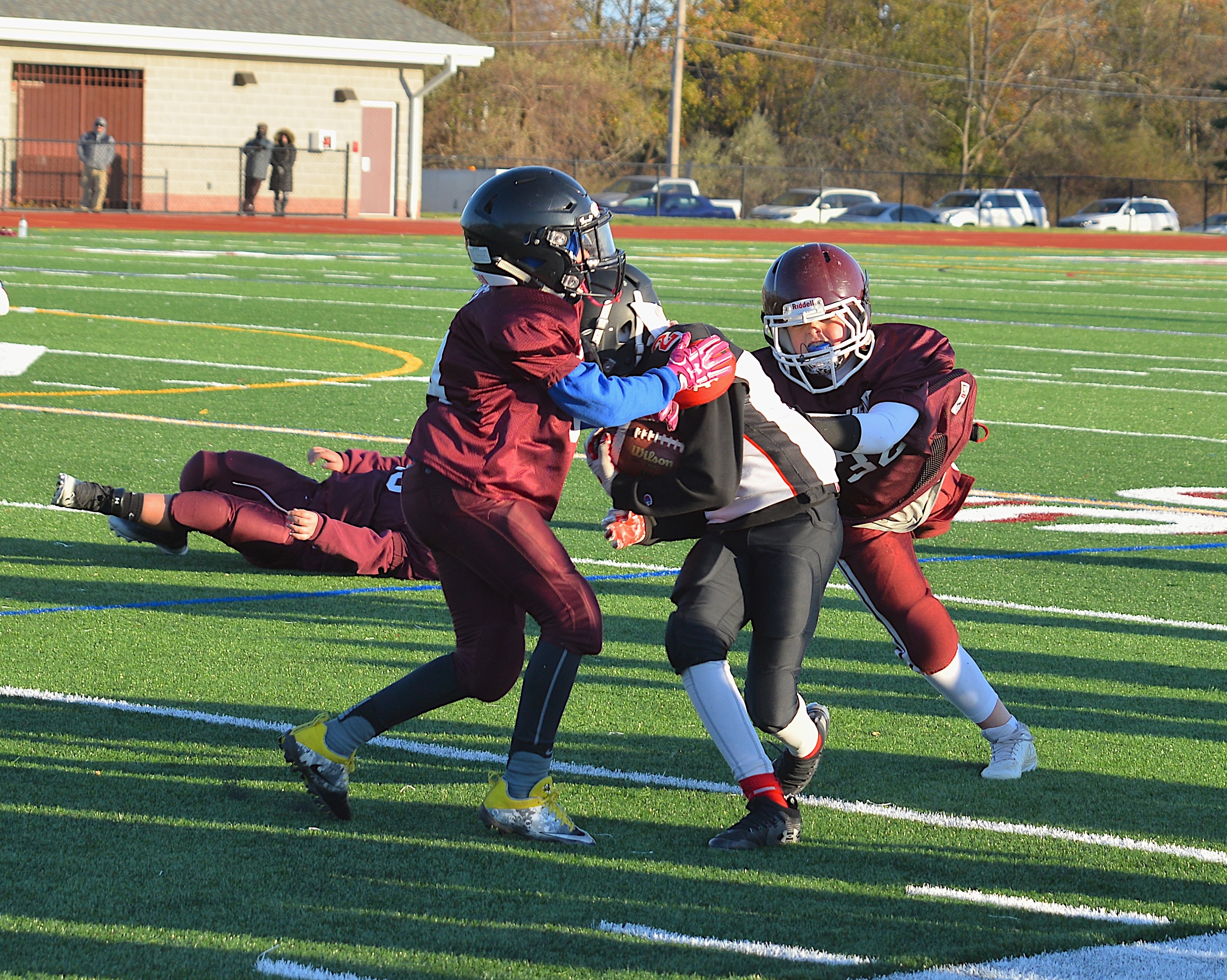 A pair of South Fork defenders tackle a Center Moriches player.