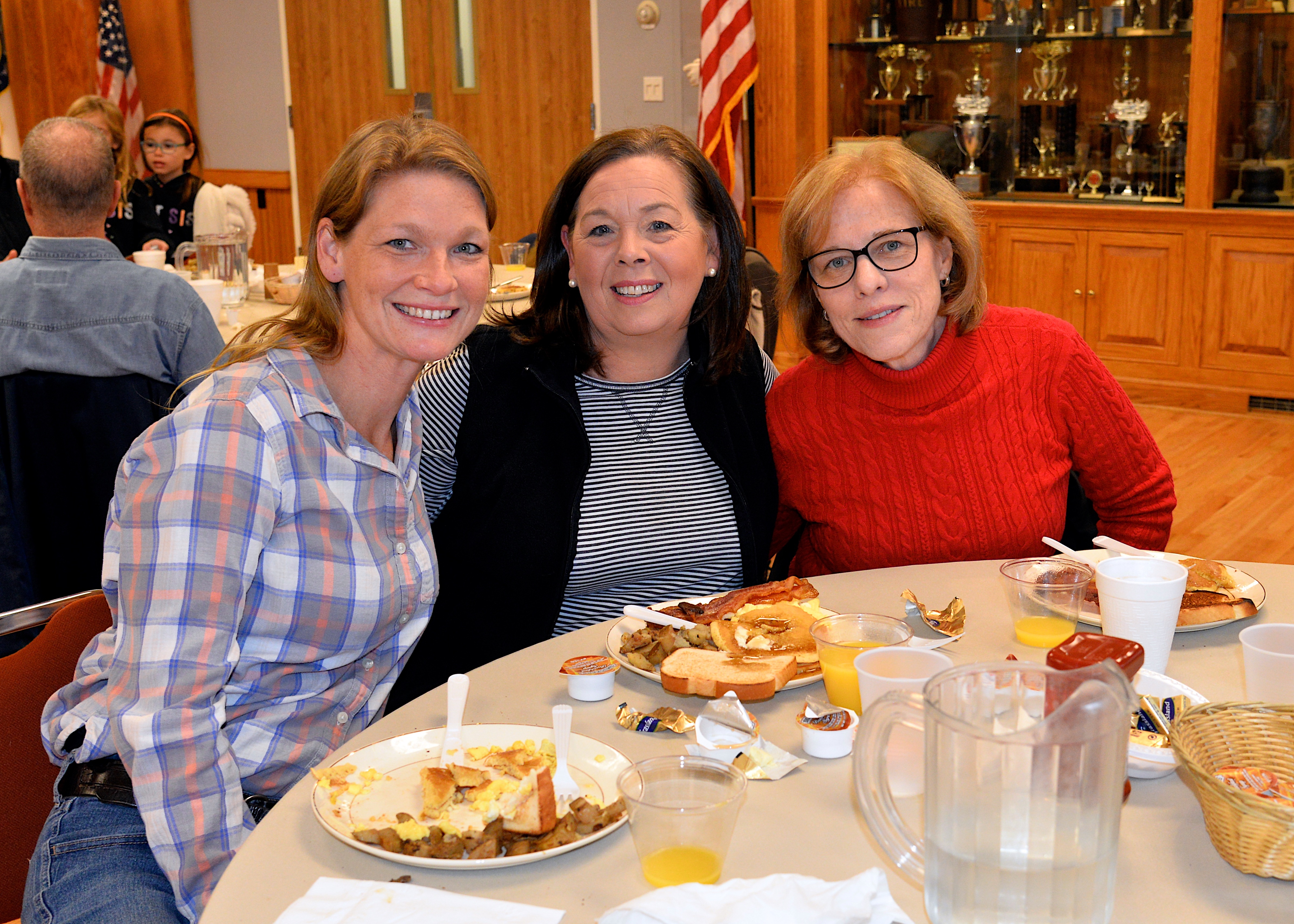 The East Hampton Fire Department hosted a pancake breakfast on Sunday, raising funds for the Eleanor Whitmore Early Childhood Center. From left, Erin Abran, Alison Anderson and Barbara Bock turned out to support the effort. KYRIL BROMLEY 