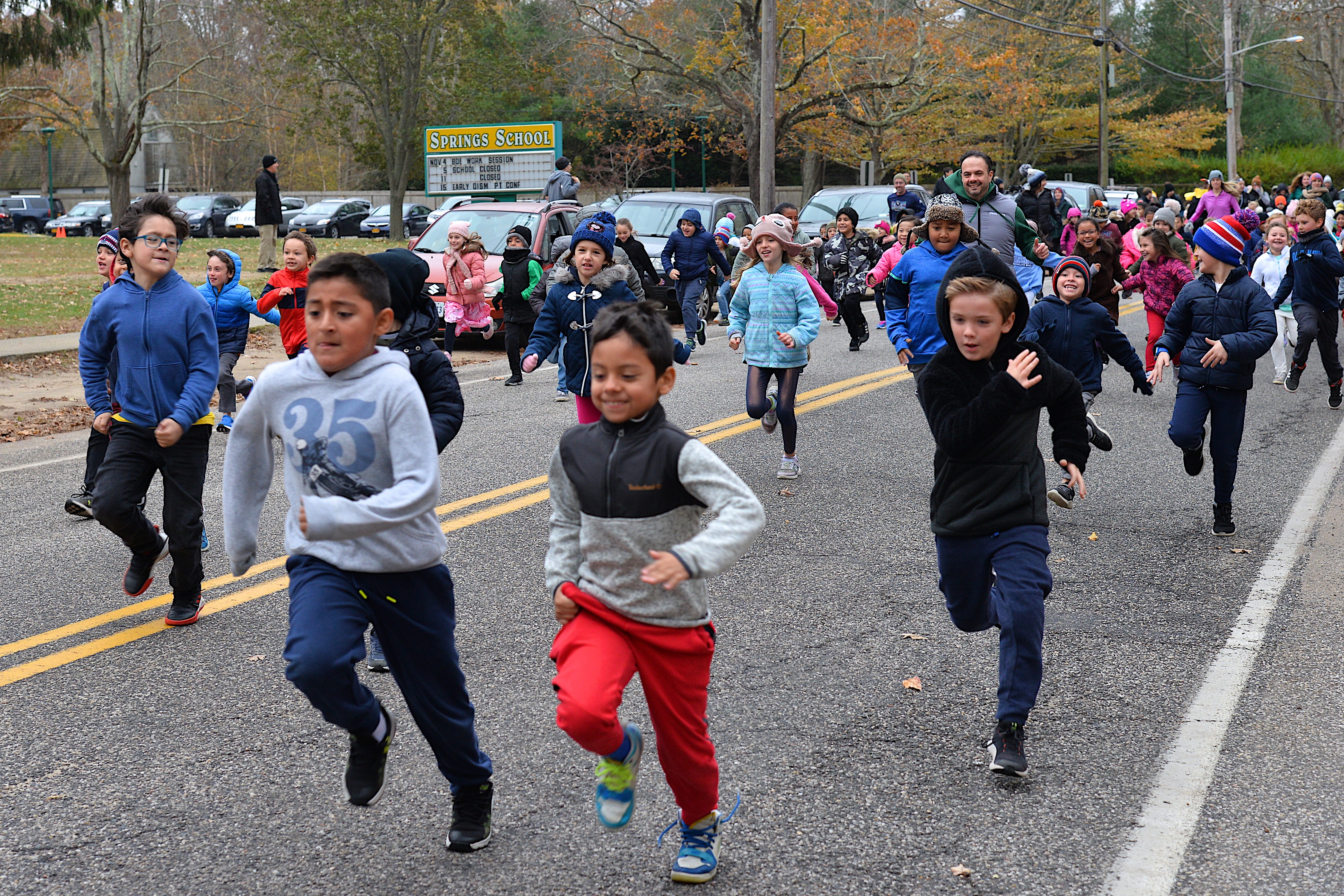 Springs School students and staff bust out the door on Monday morning for the Turkey Trot, to raise money for the school's swim program at the YMCA. KYRIL BROMLEY