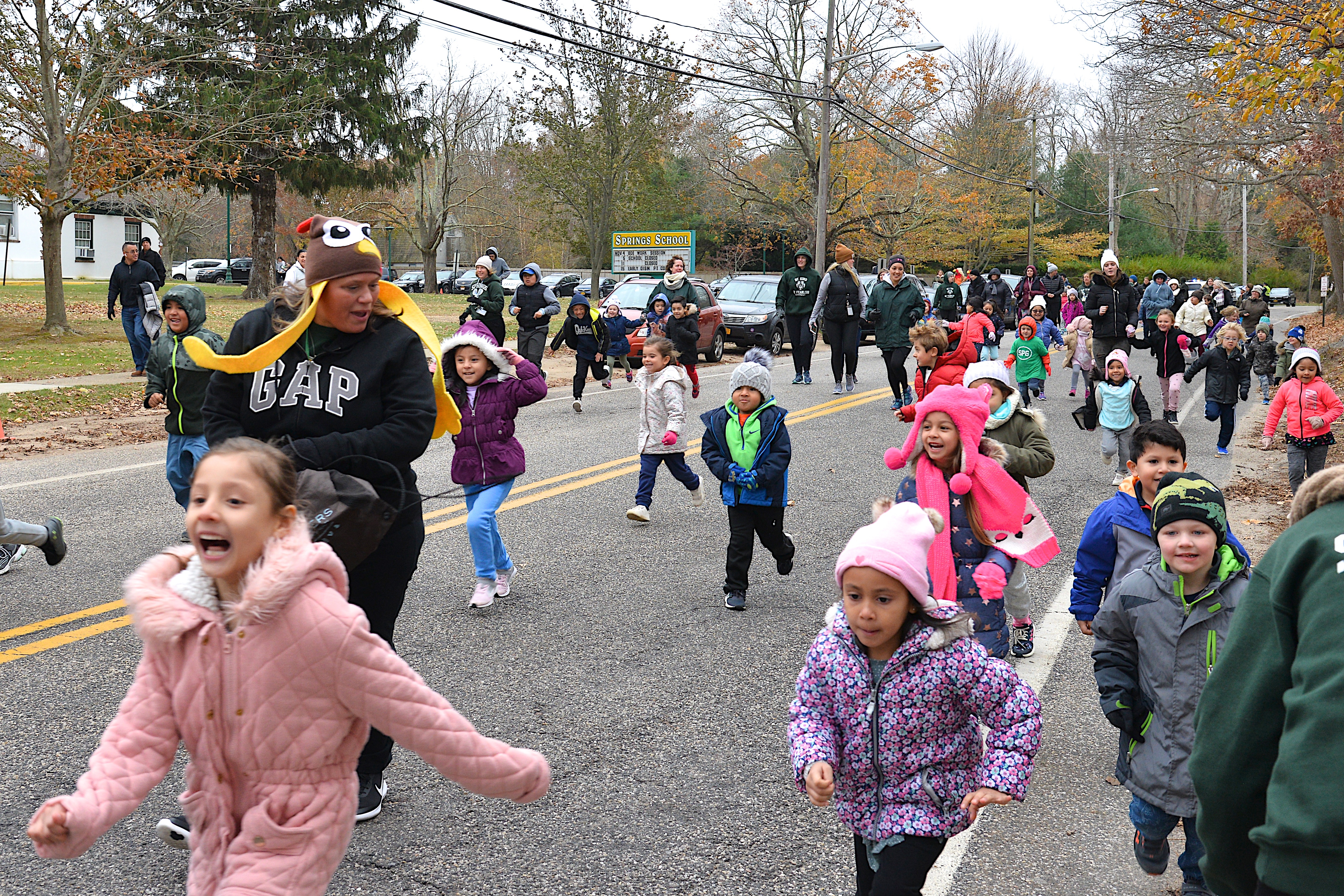 Springs School students and staff bust out the door on Monday morning for the Turkey Trot, to raise money for the school's swim program at the YMCA. KYRIL BROMLEY