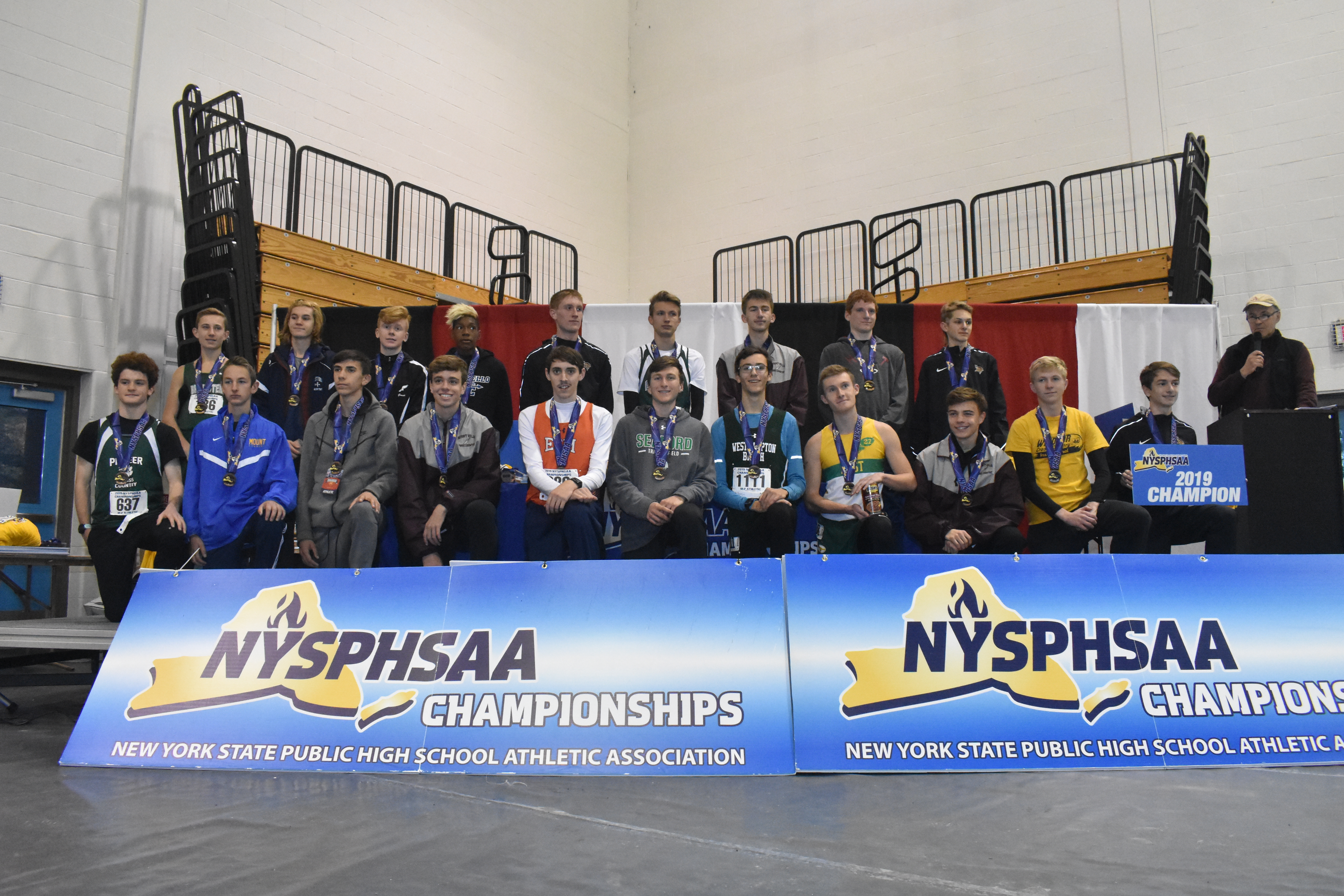Westhampton Beach sophomore Gavin Ehlers on the podium with the top 24 runners in Class B.