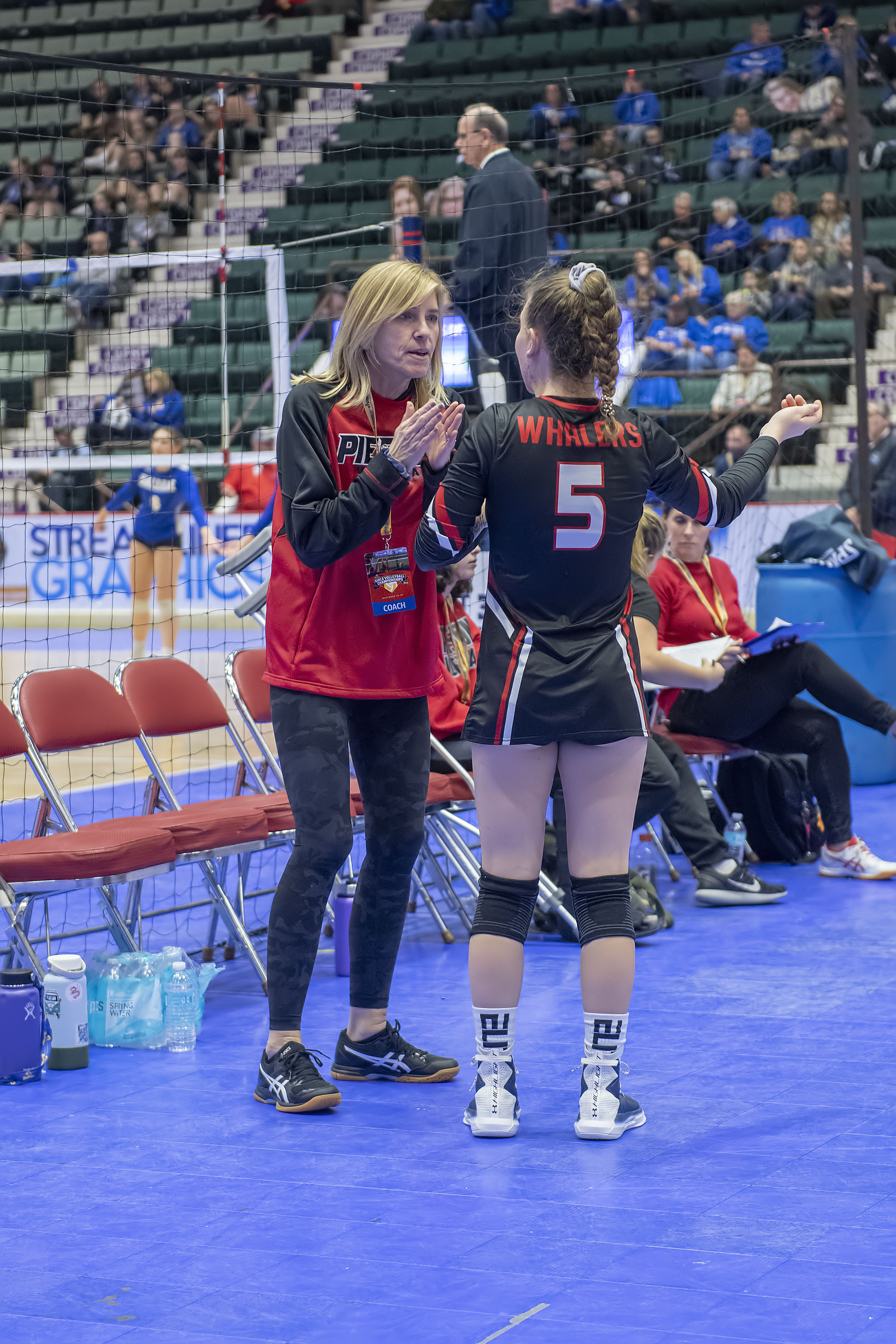 Pierson head coach Donna Fischer gives Sofia Mancino a pep talk during a timeout in the Lady Whalers' second match of the day against the Valhalla