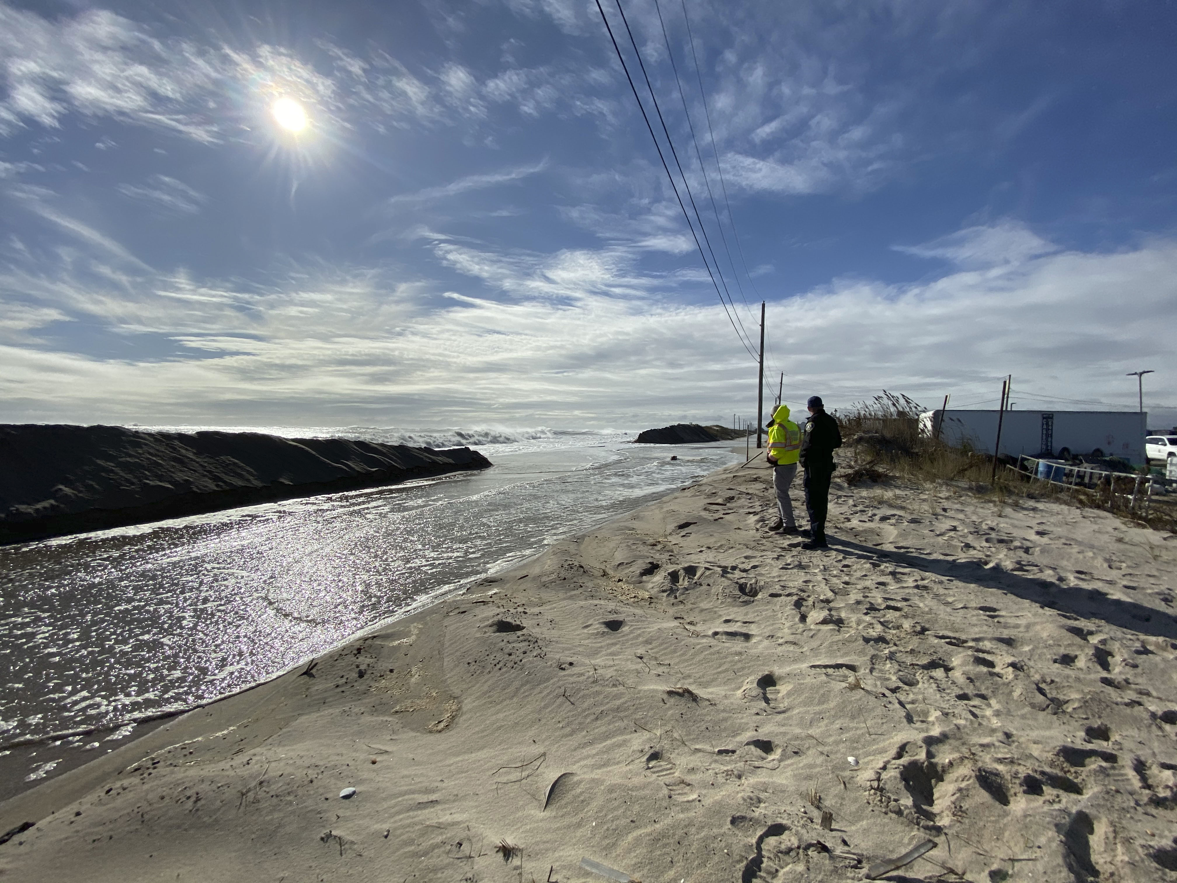 High seas wash away the dune across from the commercial fishing dock in Hampton Bays on Monday. DANA SHAW