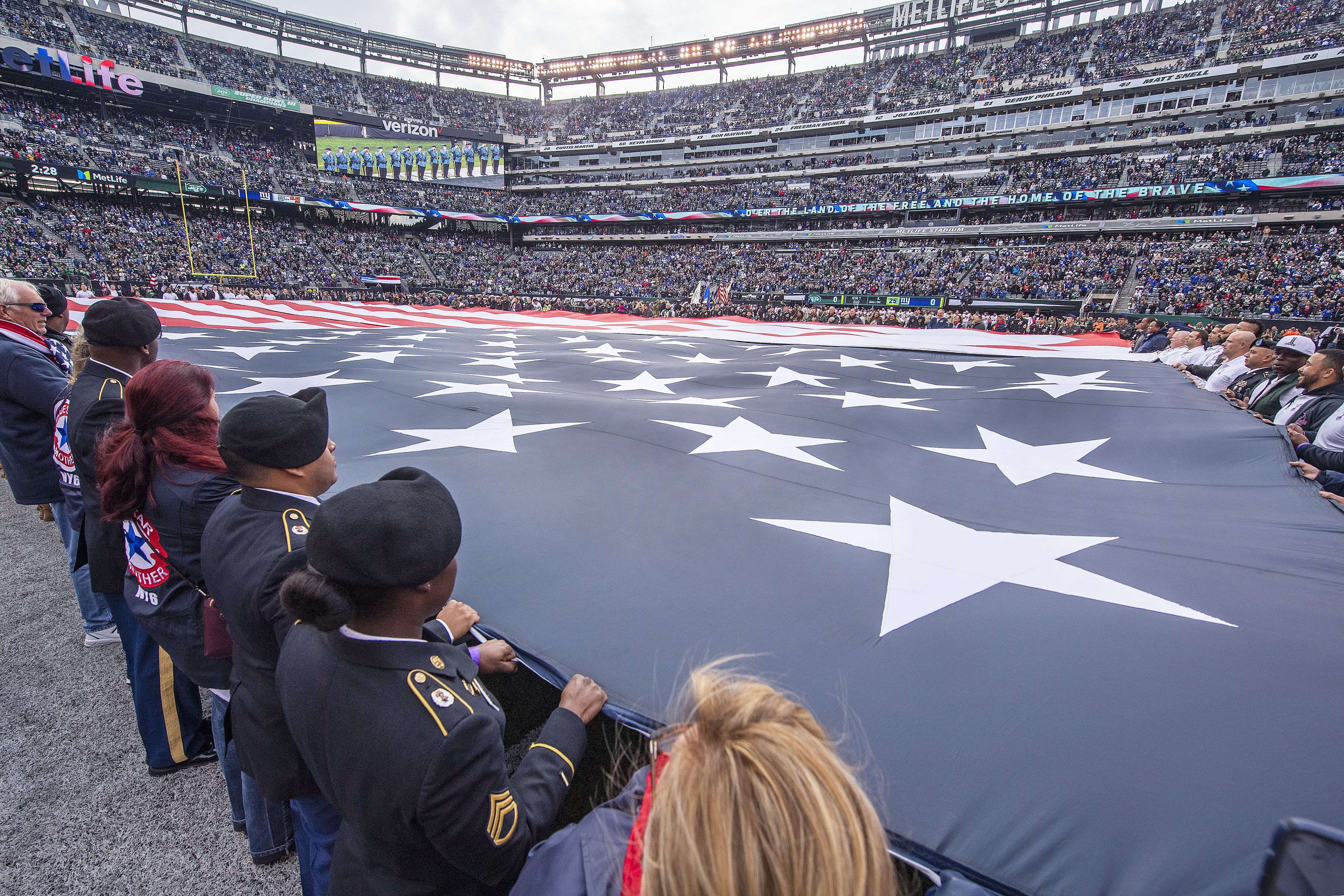Sag Harbor Gold Star Mother JoAnn Lyles joined several hundred Gold- and Blue-Star Familiesto hold a giant American flag that was presented as part of a pre-game 