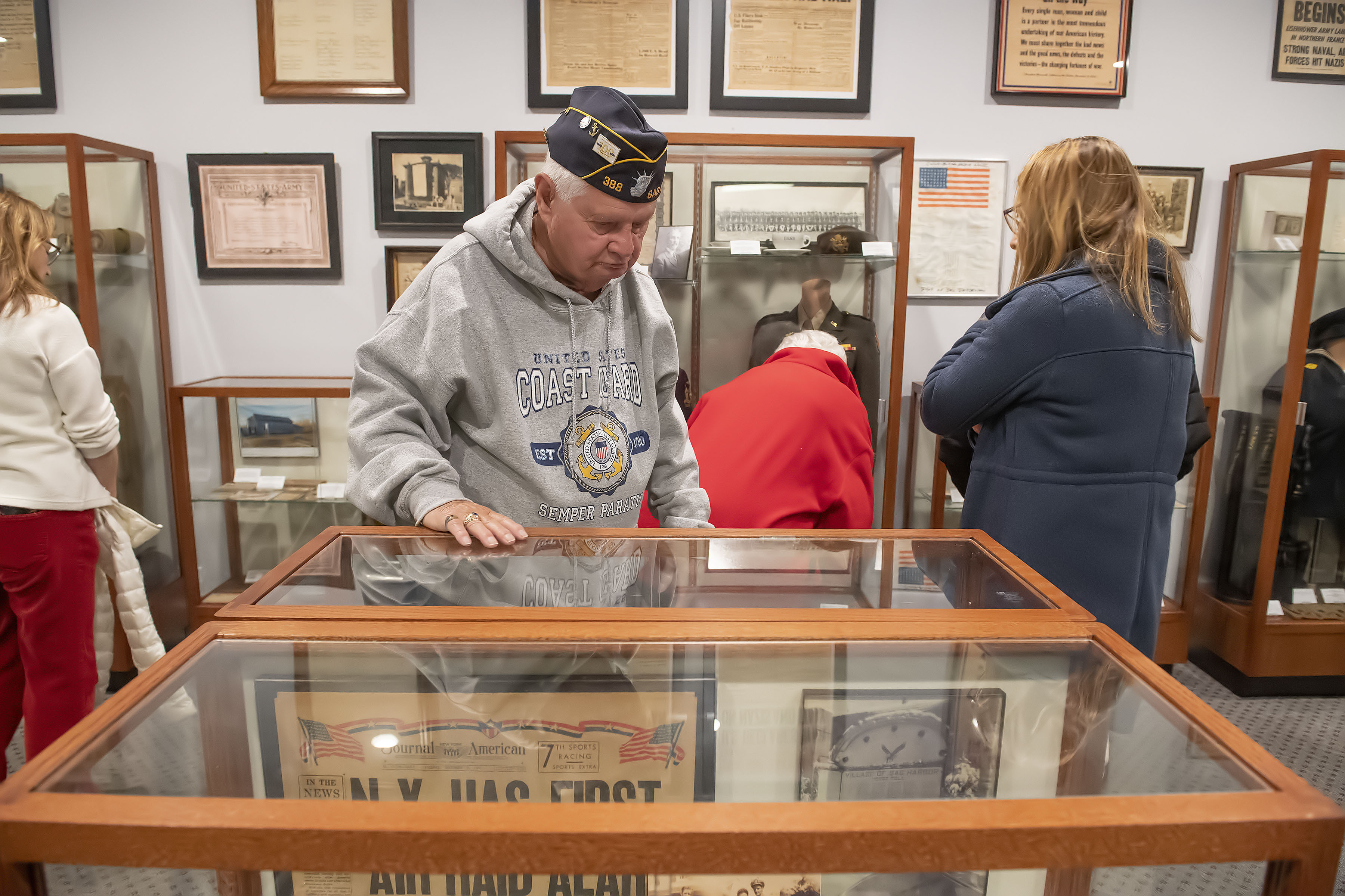 Harbord Gray checks out some of the numerous artifacts on display during the grand opening of the new museum space at the American Legion Chelberg & Battle Post 388 following the 2019 Veterans Day Parade on Monday.     MICHAEL HELLER