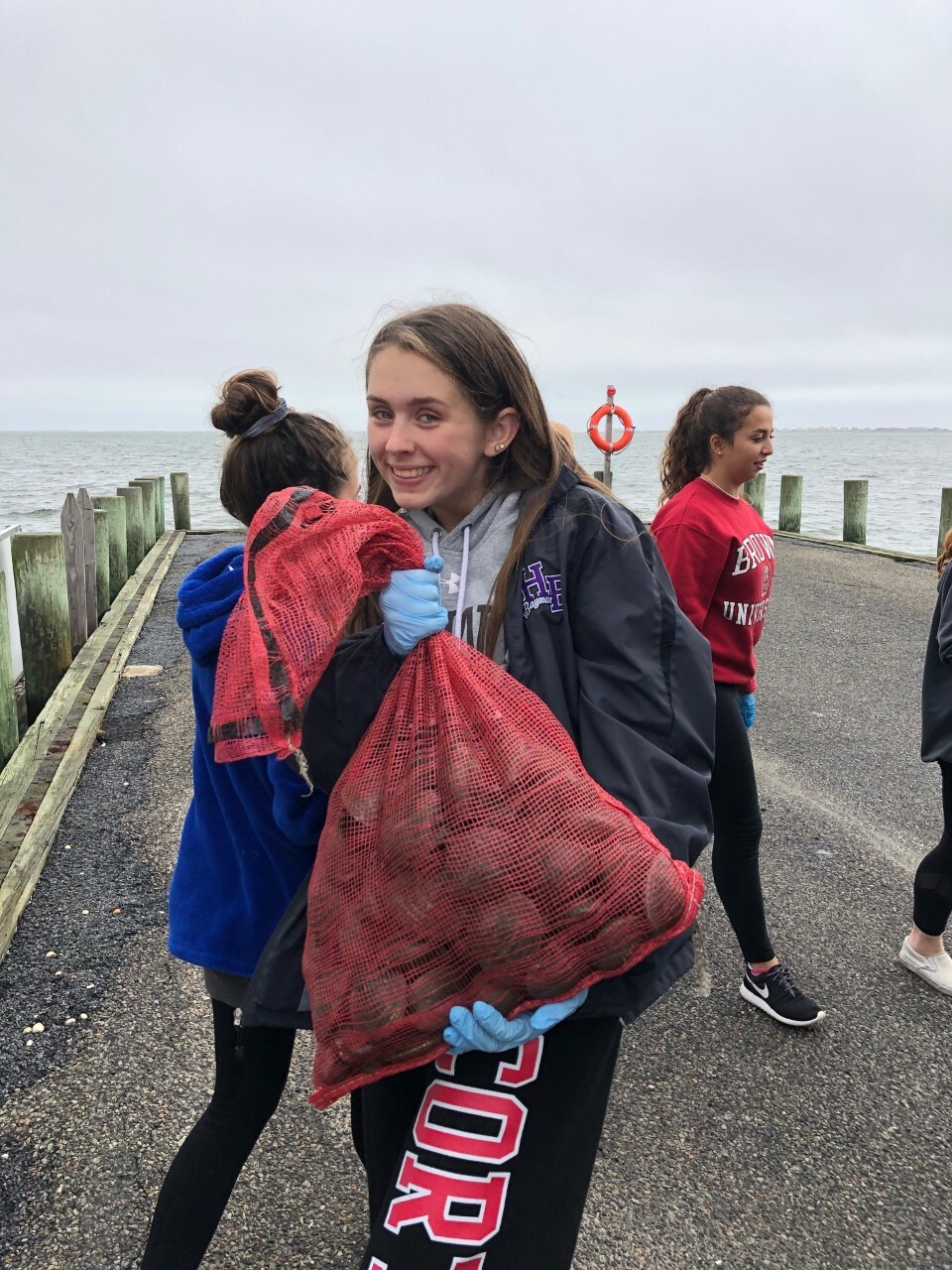Hampton Bays High School science research students are helping to restore the water quality of local bays by seeding the waters with adult clams, as part of the Shinnecock Bay Restoration Program, with help from Stony Brook University.