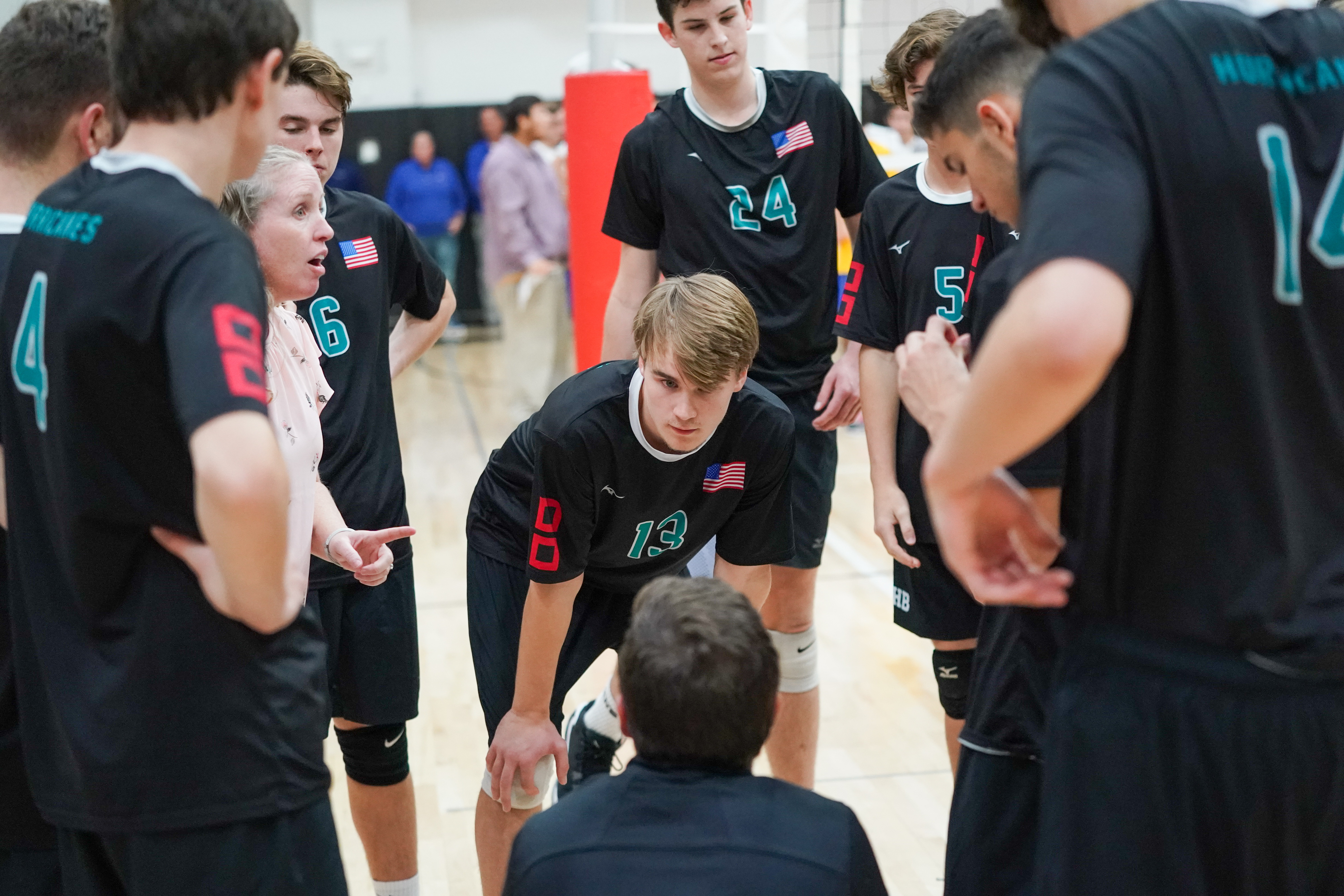 Micah Terry and the 'Canes listen to coaches Jackie Reed and Josh Tuttle during a timeout.