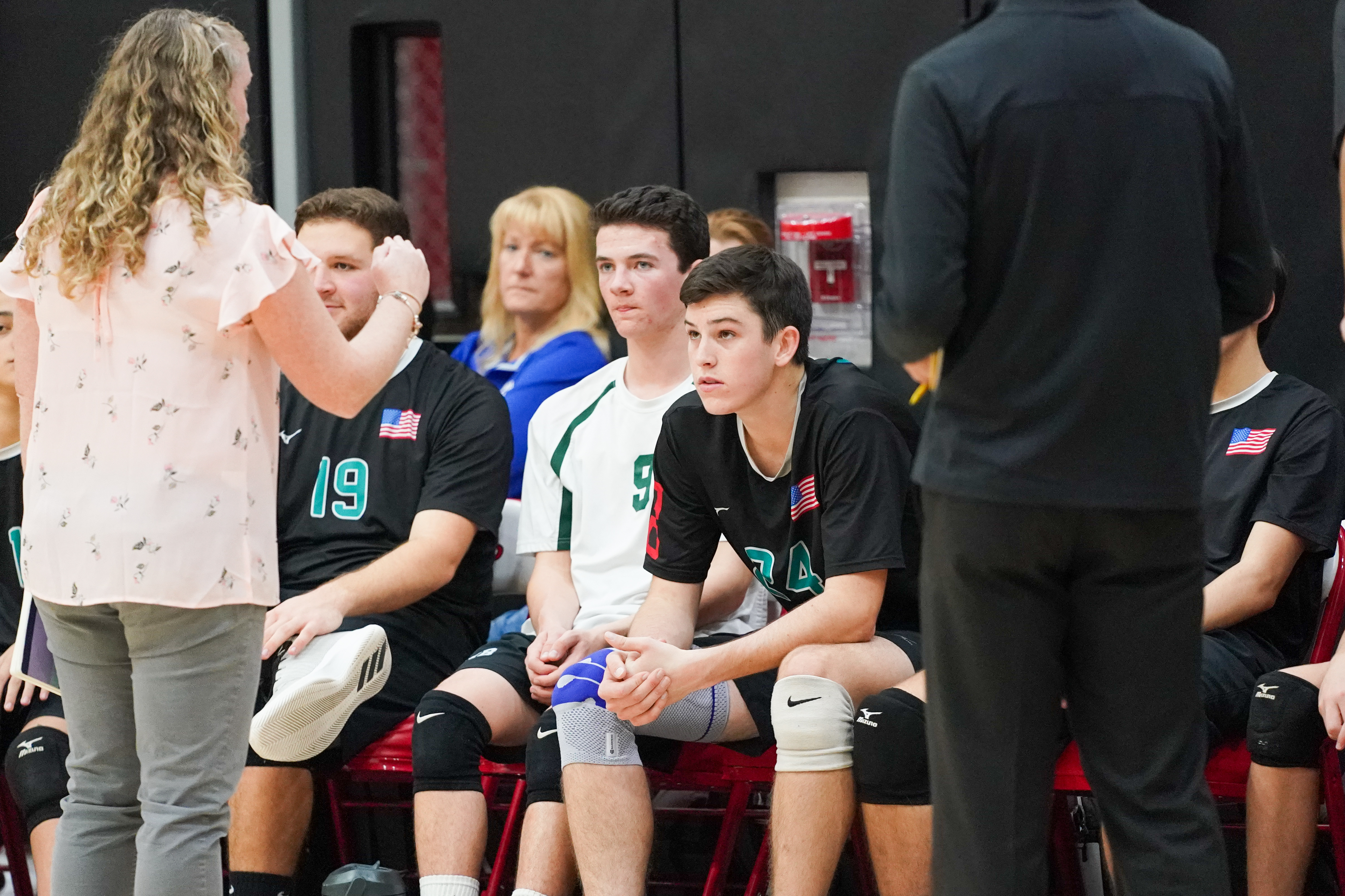 The 'Canes listen to head coach Jackie Reed during a break.