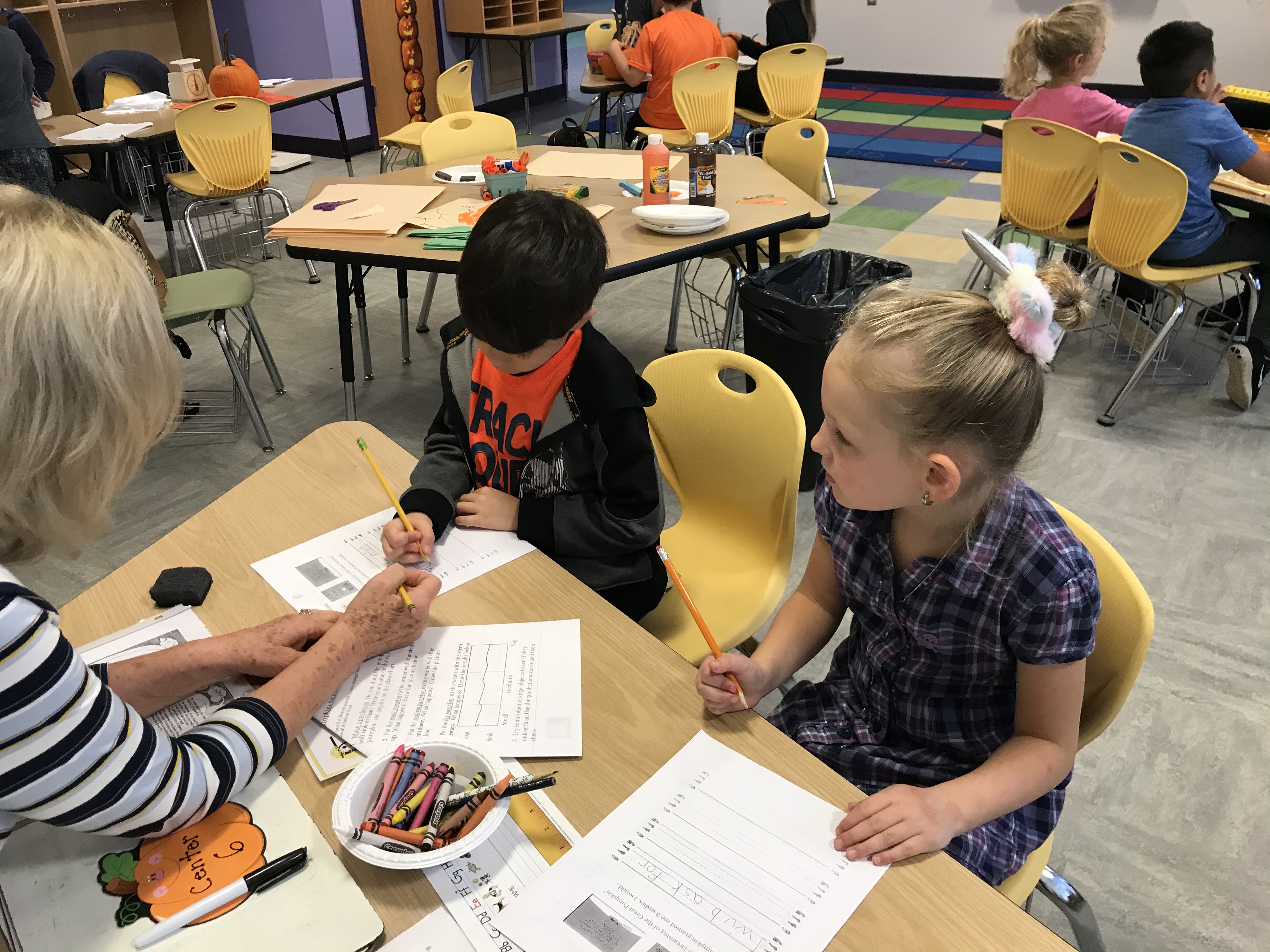 Tuttle Avenue Elementary students collecting data and creating art with their pumpkins. 