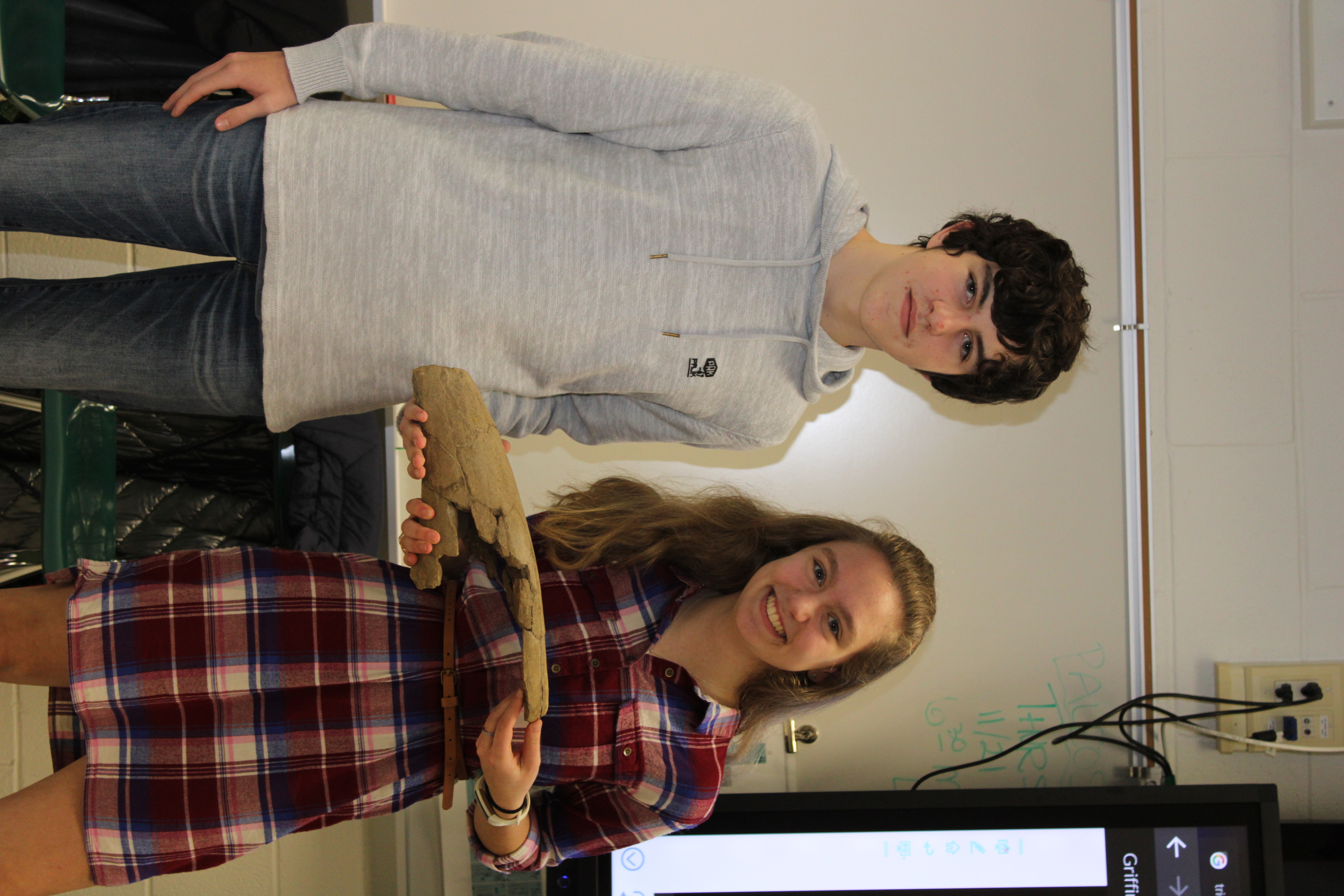 Westhampton Beach High School Sophomores Griffin Scheurer and Julia Blydenbuergh with the triceratops horn they've been studying. 