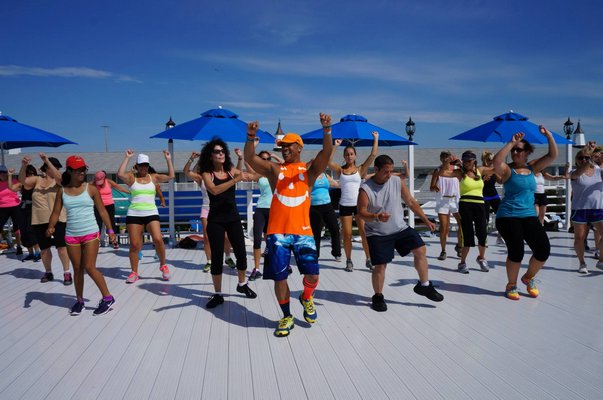Oscar Gonzalez teaching his Zumba At The Beach class in Westhampton Beach. SUBMITTED PHOTO