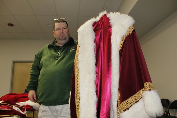Jay Mooney holds up his old-fashioned Santa robe. KATE RIGA