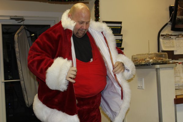Bill John Koehler straps on his Santa belly. KATE RIGA