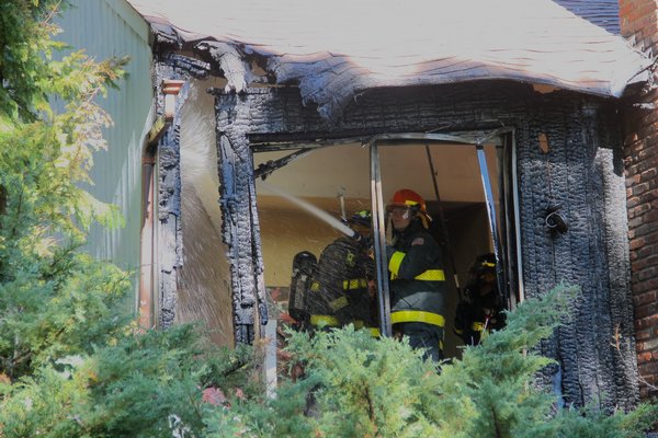 East Hampton firefighters battled a blaze at a house on Hands Creek Road on Monday afternoon. KYRIL BROMLEY
