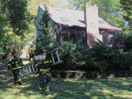 East Hampton firefighters battled a blaze at a house on Hands Creek Road on Monday afternoon. KYRIL BROMLEY