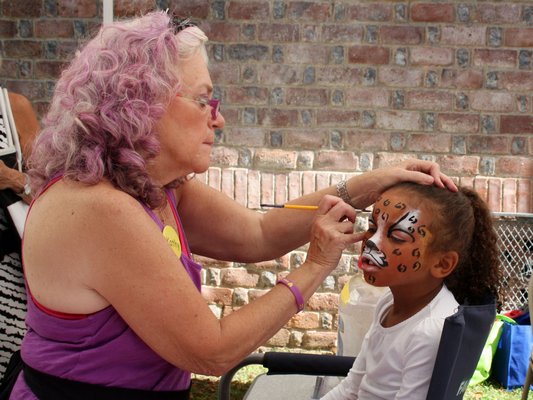 Mya Halsey gets her face painted by Kathy of Fancy Faces.