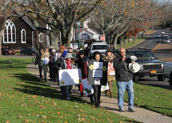  leads protesters through East Hampton Village on Saturday to demand an end to the village’s deer sterilization program. KYRIL BROMLEY