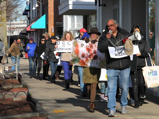 Protesters marched in East Hampton Village on Saturday afternoon demanding an end to the village’s deer sterilization program. KYRIL BROMLEY