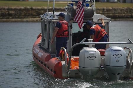  both boatswain’s mates of Coast Guard Station Montauk coordinate search efforts for a person in the water while standing as radio watchstanders