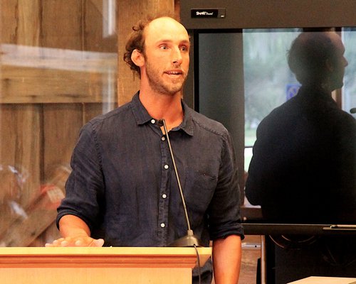 Surf instructor Corey Senese of Corey's Wave speaks at a Town Board meeting to address surf schools at Ditch Plains Beach. KYRIL BROMLEY