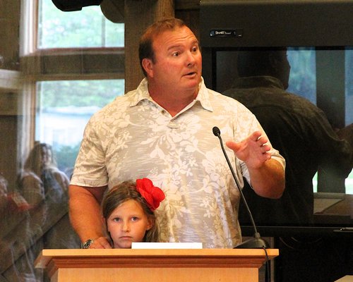 Mike and Katie Grande speaks at a Town Board meeting to address surf schools at Ditch Plains Beach. KYRIL BROMLEY