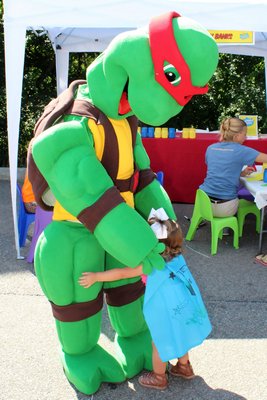 A Teenage Mutant Ninja Turtle gets a hug.