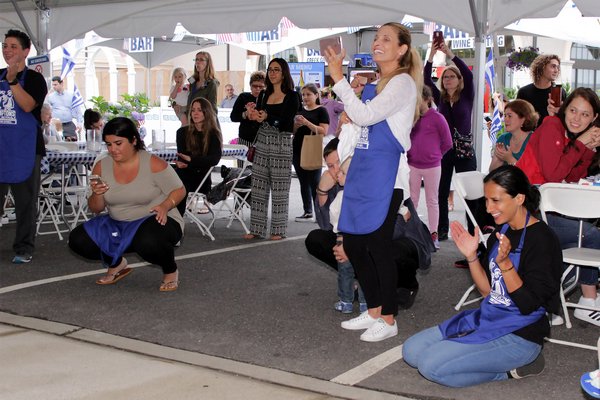 The crowd encourages the dancers.