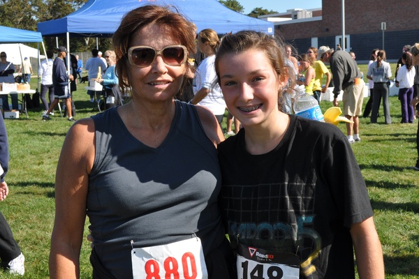 Hampton Bays School Nurse Nancy Slowey with 8th grade student Drew Zaweski at the finish of the Over the Bridge 5K race.
