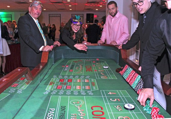 Rolling the dice at the craps table.