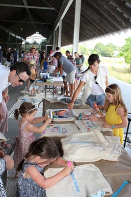 Kids decorationg tote bags at the Parrish Family Party on Sunday.