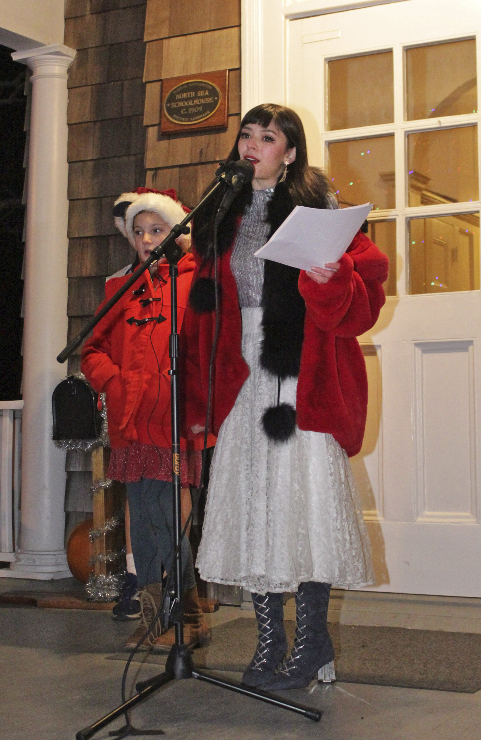 Singer Natasha Malak leads the crowd in some Christmas carols.