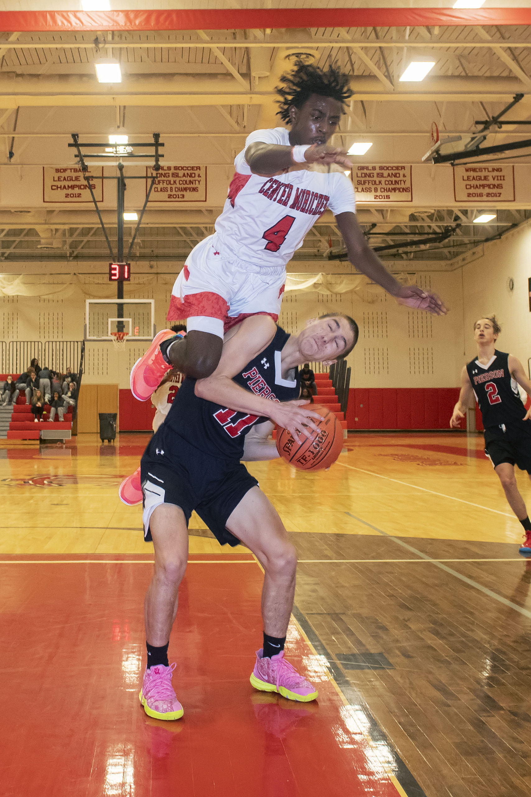 Pierson's Nick Egbert draws Dayrien Franklin of Center Moriches to leap.