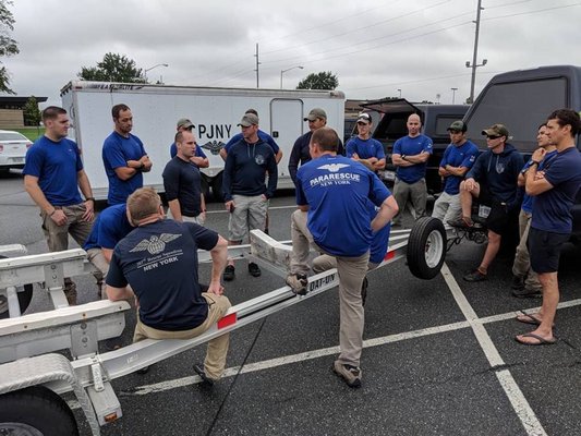 Members of the 103rd Rescue Squadron of the 106th Rescue Wing assigned to the New York Air National Guard coordinate their movement south at Dover Air Force Base