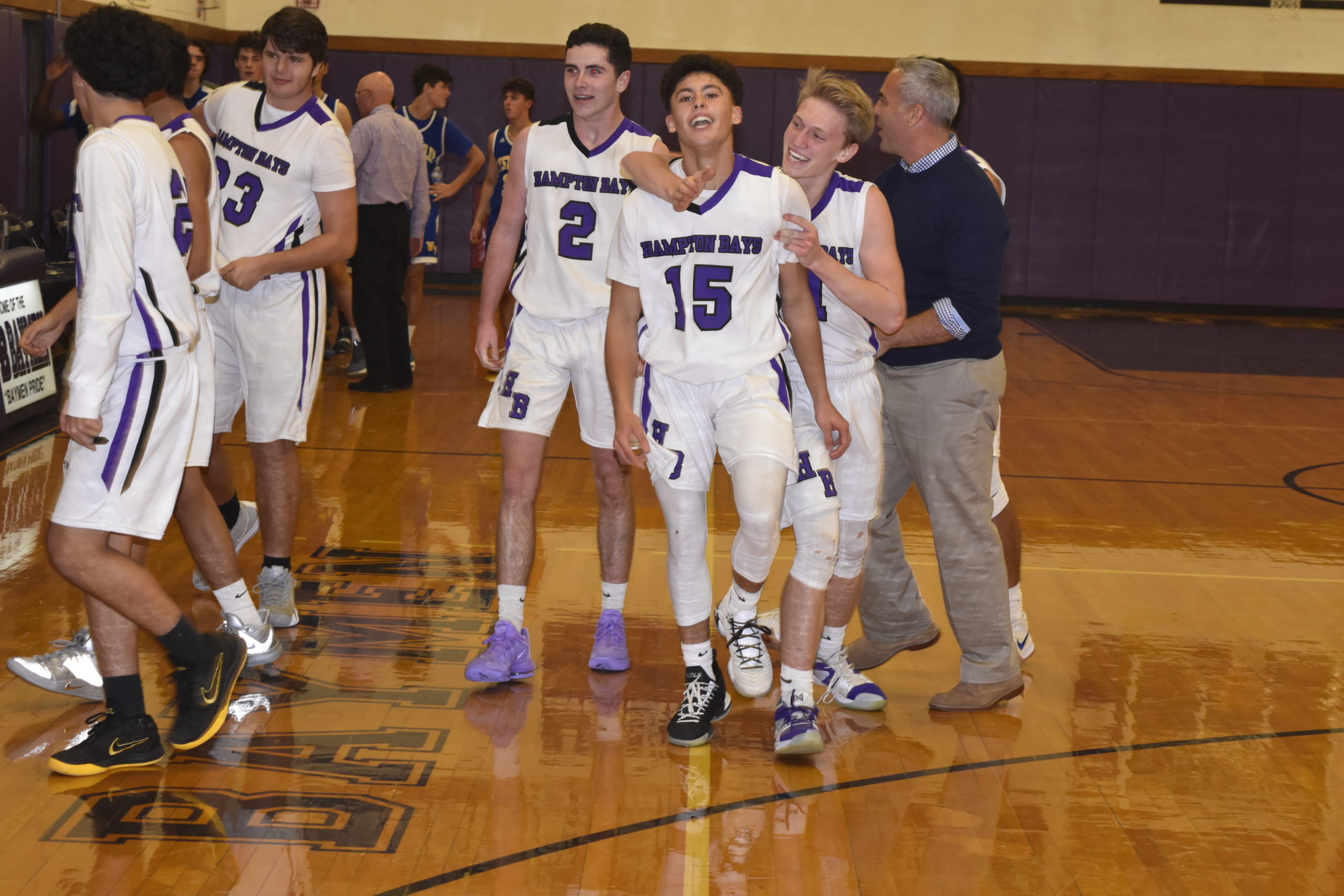 Lucas Brown and other teammates congratulate Steven Mora after his half-court buzzer beater led to a 54-51 victory over West Islip on Friday night.